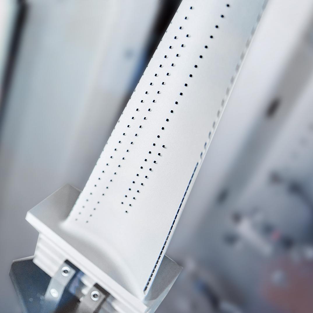 The image shows cooling holes in the blade, essential for airflow protection, precisely reopened during the finishing process.