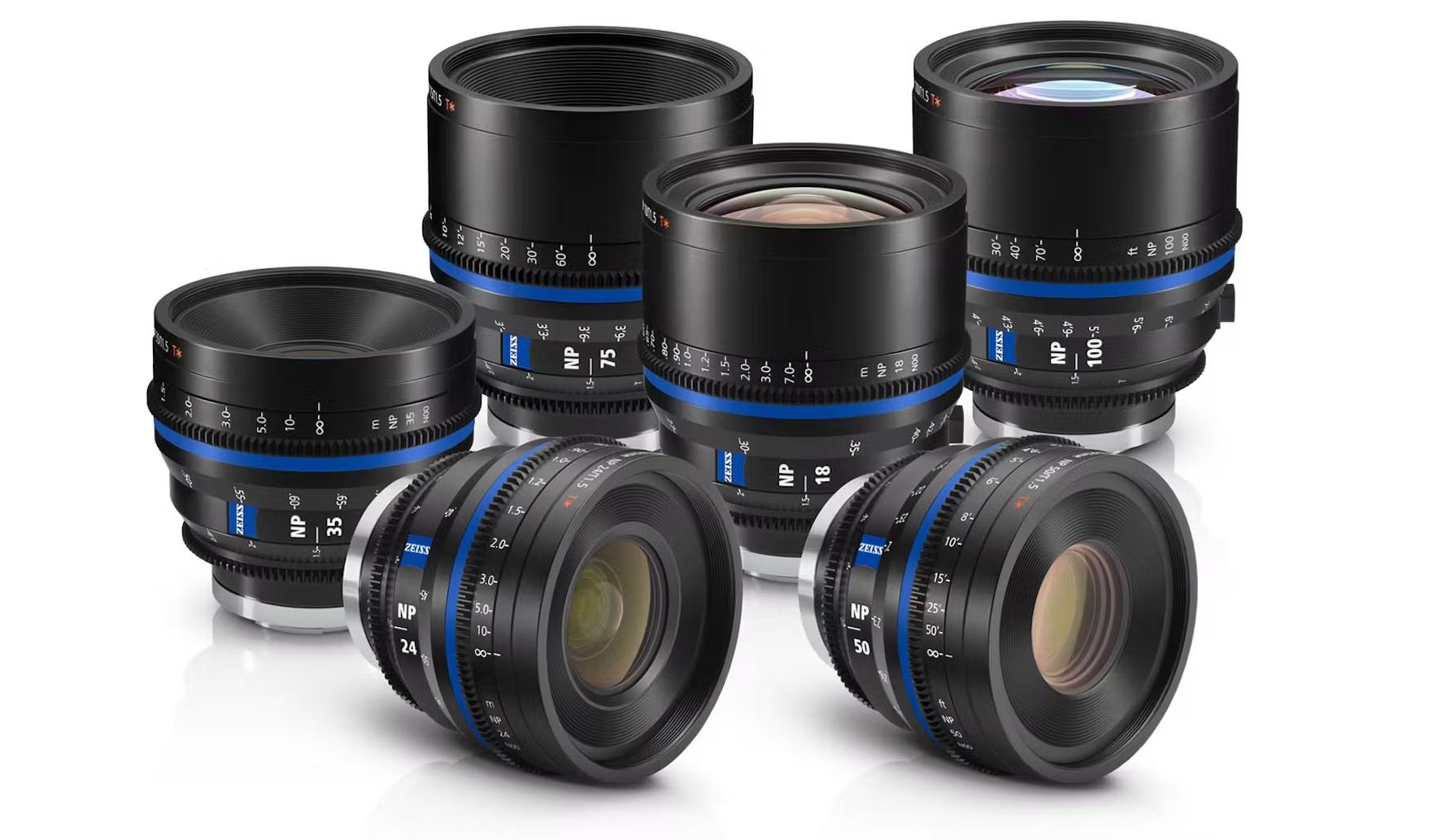 Six professional ZEISS camera lenses with blue accents are arranged in two rows on a white background.