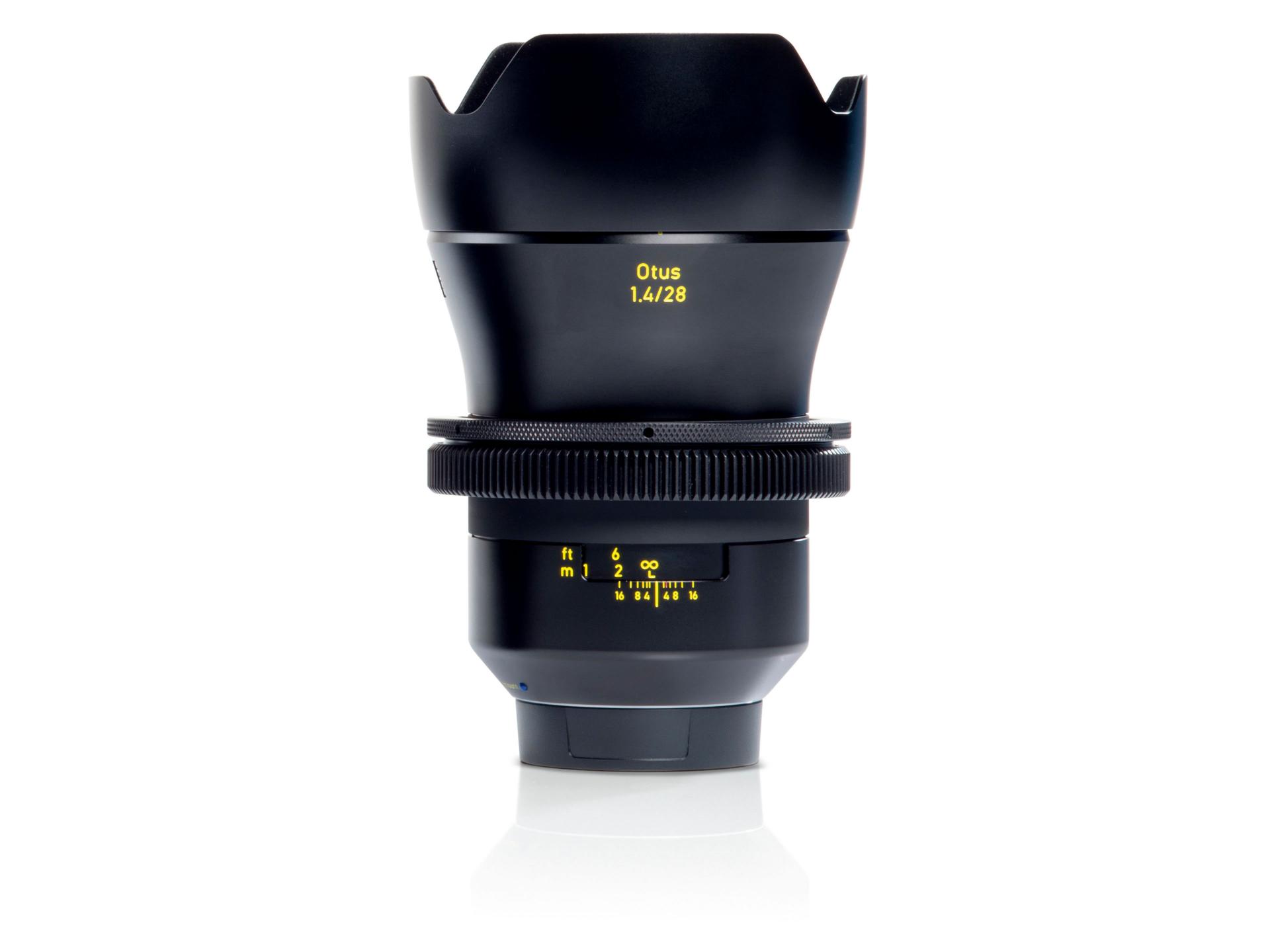 Professional product image of a ZEISS Otus 1.4/28 camera lens with focus and aperture markings clearly visible.