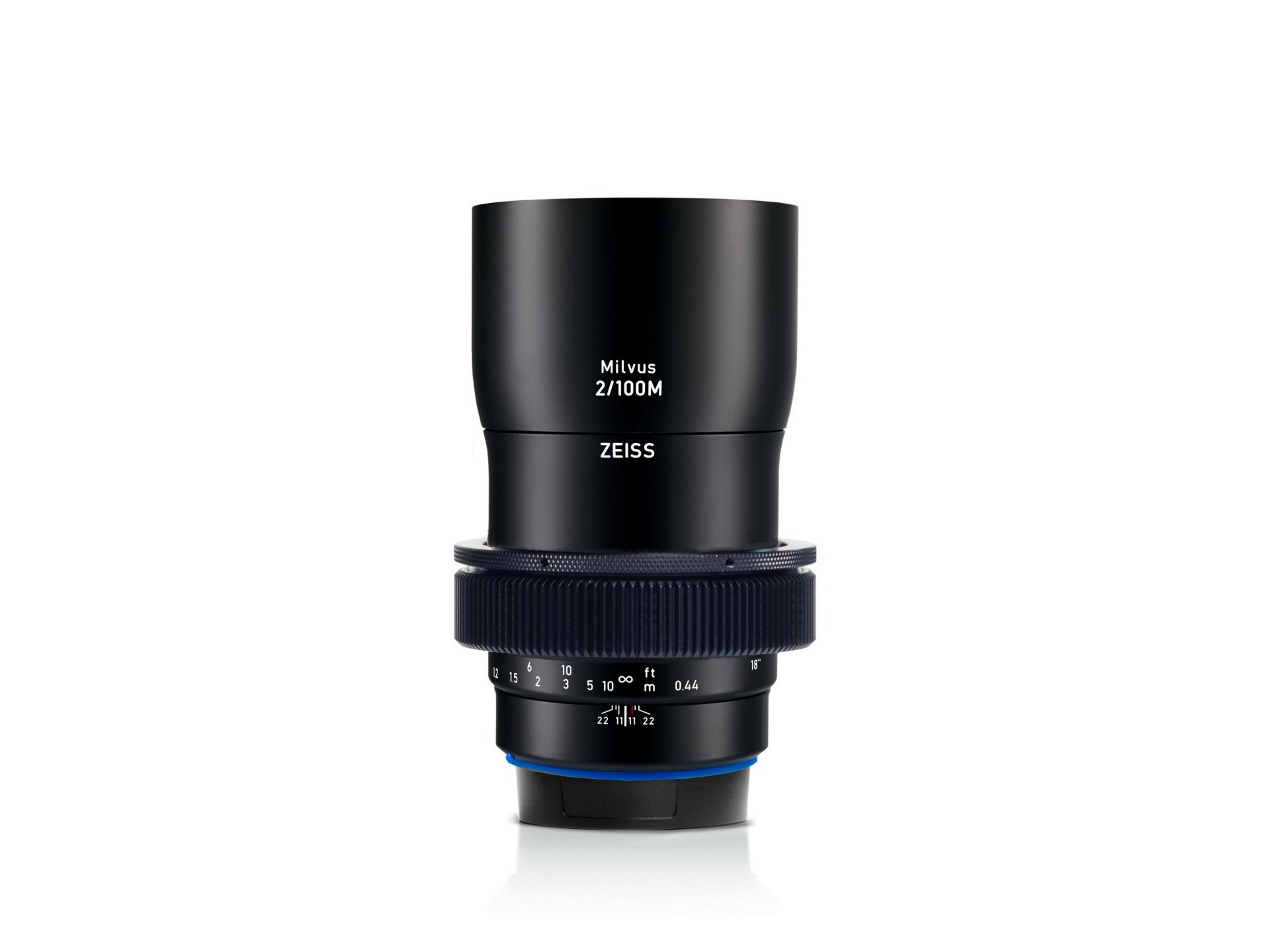 Black ZEISS Milvus 2/100M camera lens standing upright on a white background, showcasing detailed focus and aperture markings.