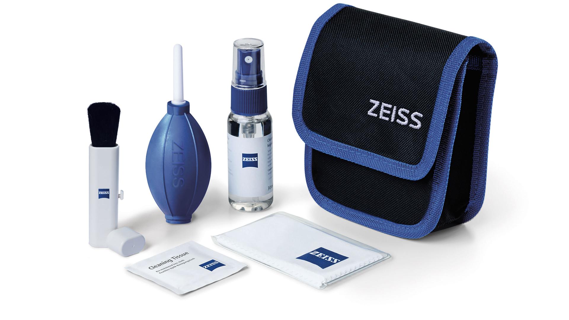 ZEISS camera cleaning kit including a lens cleaning brush, air blower, cleaning spray, microfiber cloths, and a black and blue carrying pouch with ZEISS branding.