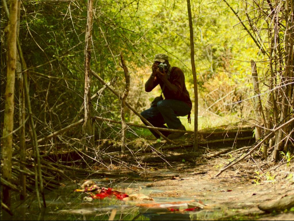 Two people are working with professional film production equipment, including a camera and monitor, in a studio setting featuring ZEISS lenses.