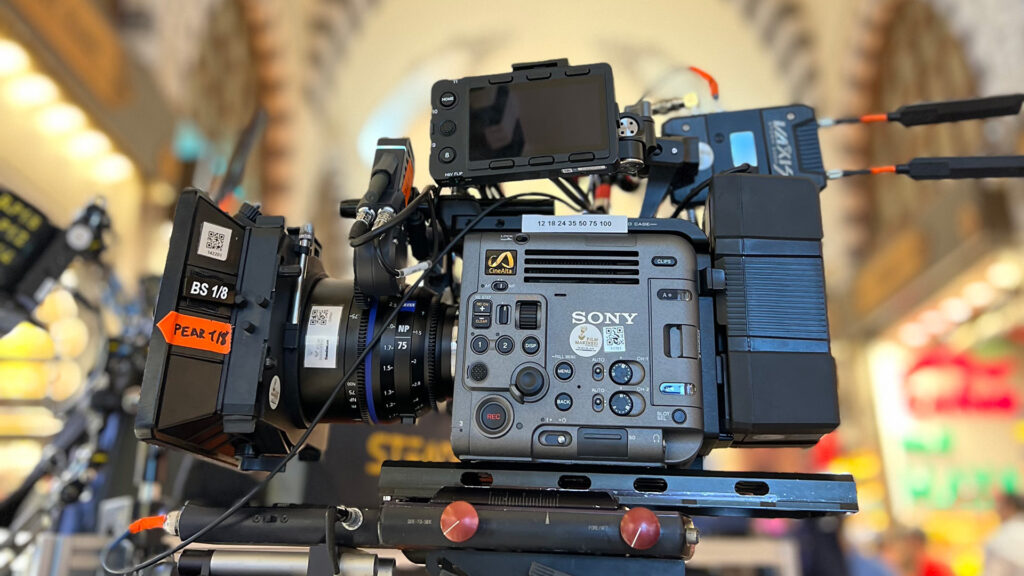 Professional cinema camera rig featuring a ZEISS lens mounted on a SONY camera, set up in a brightly lit indoor location.