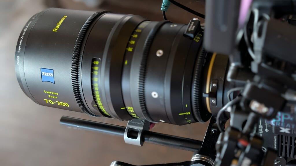 Close-up of a ZEISS Supreme Prime 70–200mm camera lens mounted on a professional film rig.