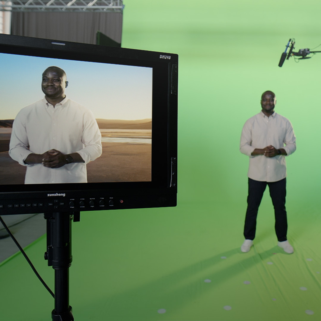 A professional green screen setup displaying a presenter in a virtual environment, showcasing ZEISS advanced filming and visual technology.
