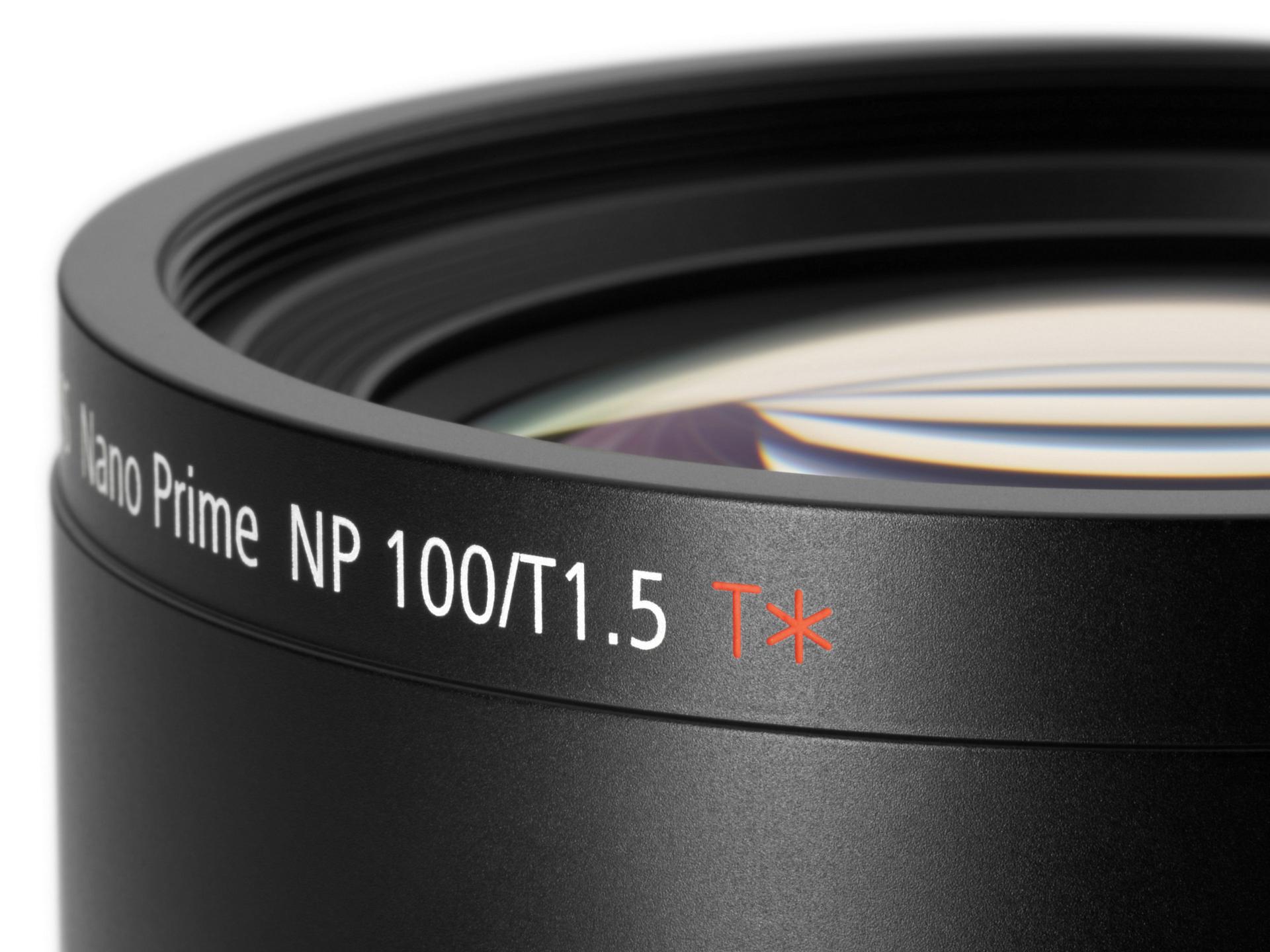 Close-up of a ZEISS Nano Prime NP 100/T1.5 lens showing the engraved model details and T* coating mark on the lens barrel.