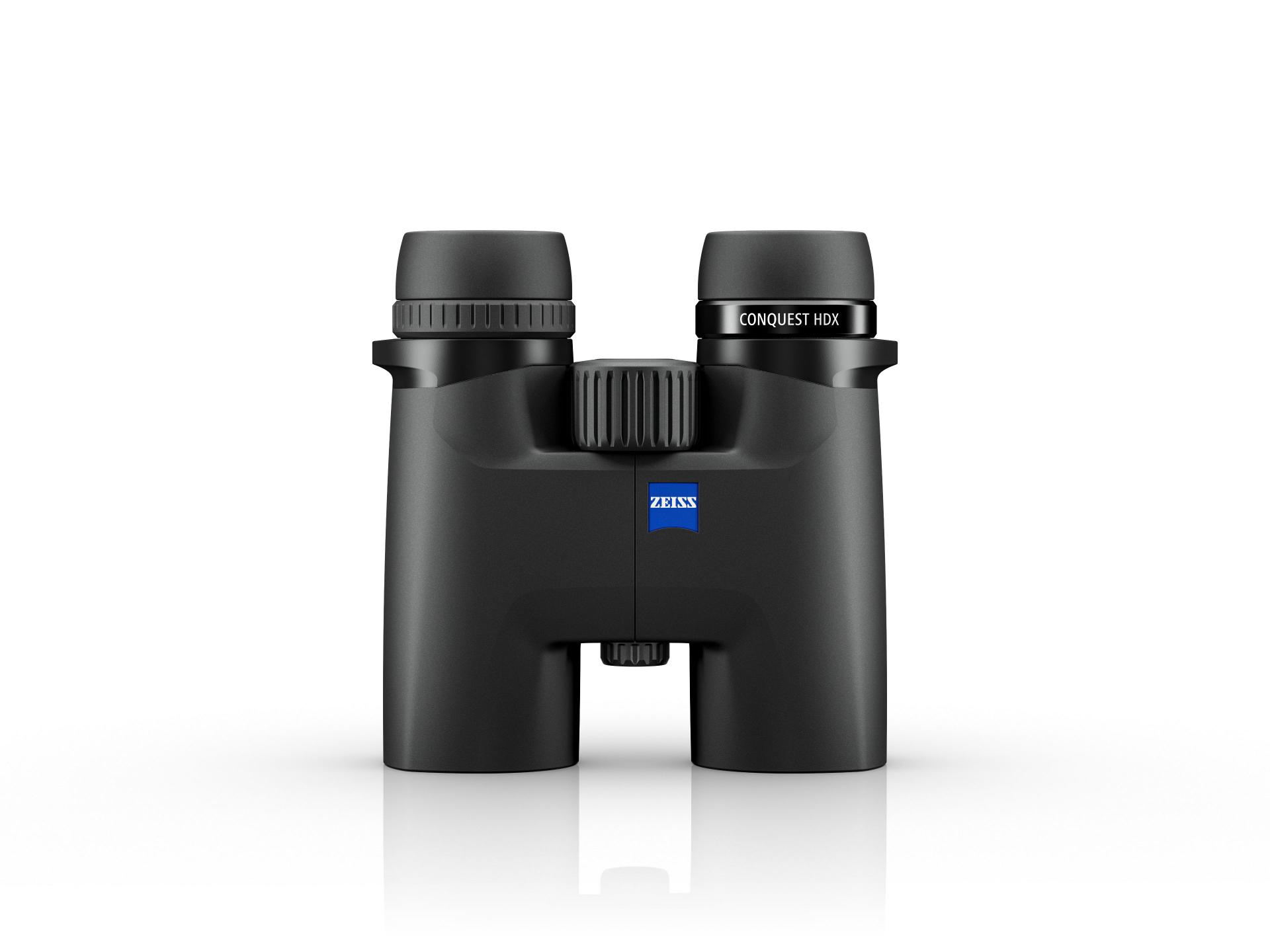 Black ZEISS CONQUEST HD binoculars with a central focusing wheel, displayed upright on a white reflective surface.