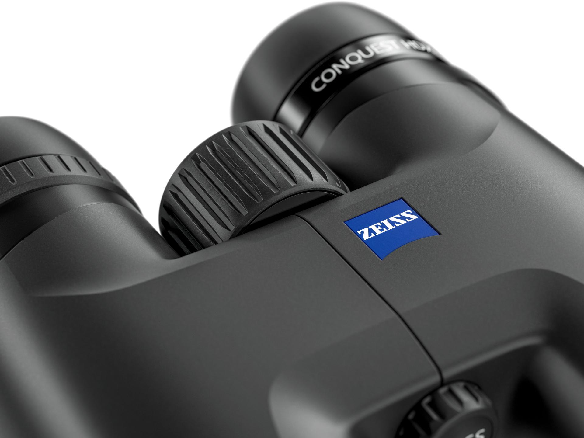 Close-up view of a pair of ZEISS binoculars featuring the central focus wheel and the ZEISS logo.