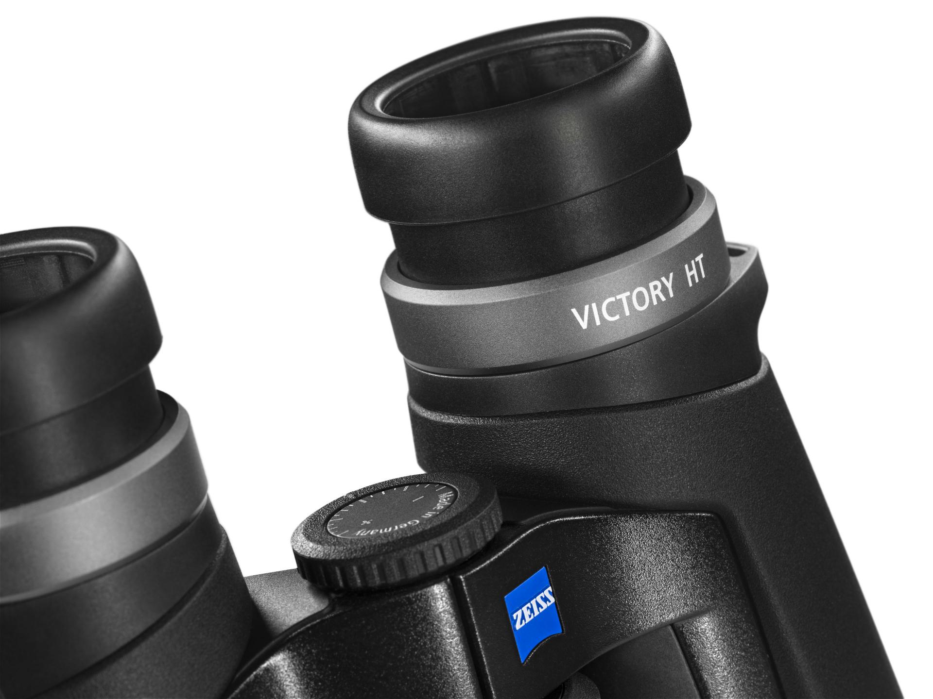 Close-up view of ZEISS VICTORY HT binoculars showing the eyepieces, central focusing wheel, and ZEISS logo.