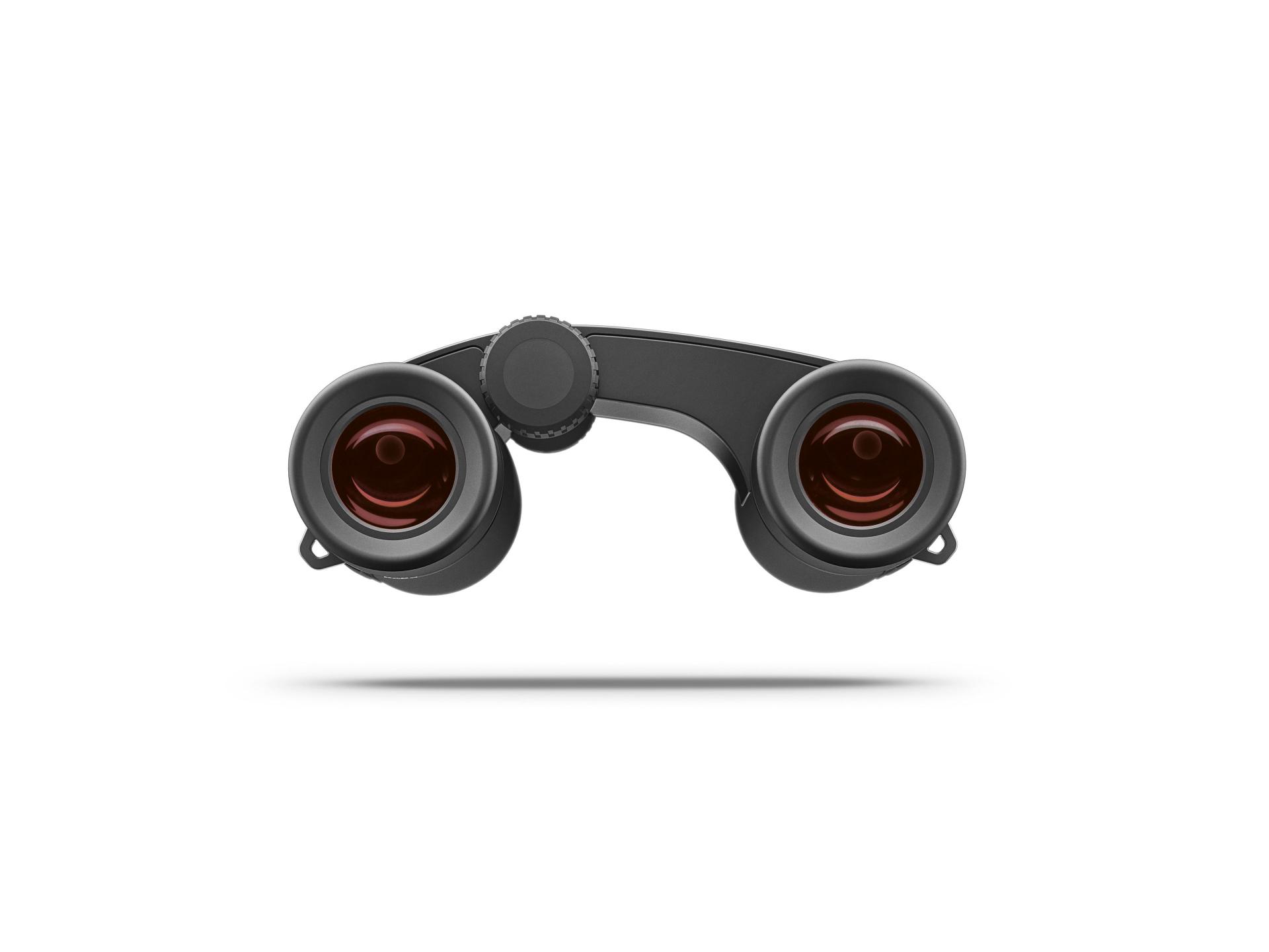 Front view of a compact black ZEISS binocular with large red-tinted objective lenses and a central focusing wheel.