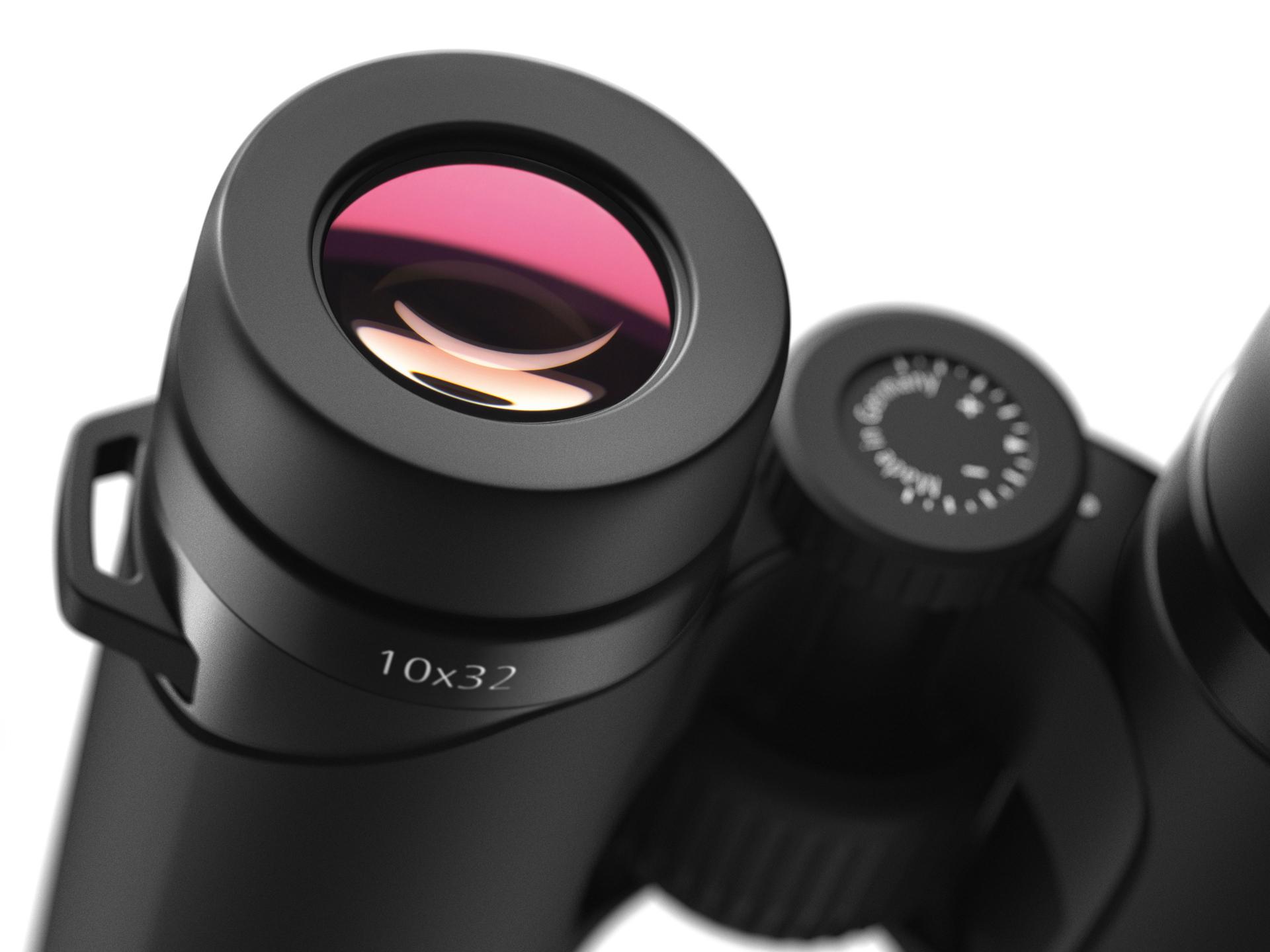 Close-up view of a ZEISS 10x32 binocular lens with detailed focus on the eyepiece and adjustment dial.