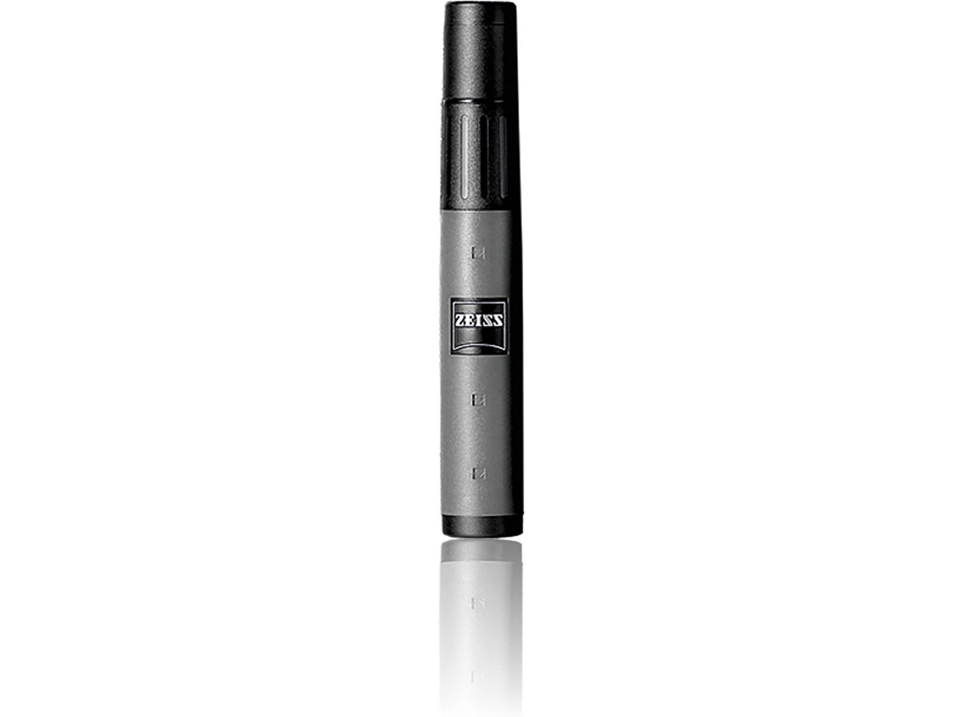 Black and gray ZEISS lens cleaning brush with logo, standing upright on a white reflective surface.