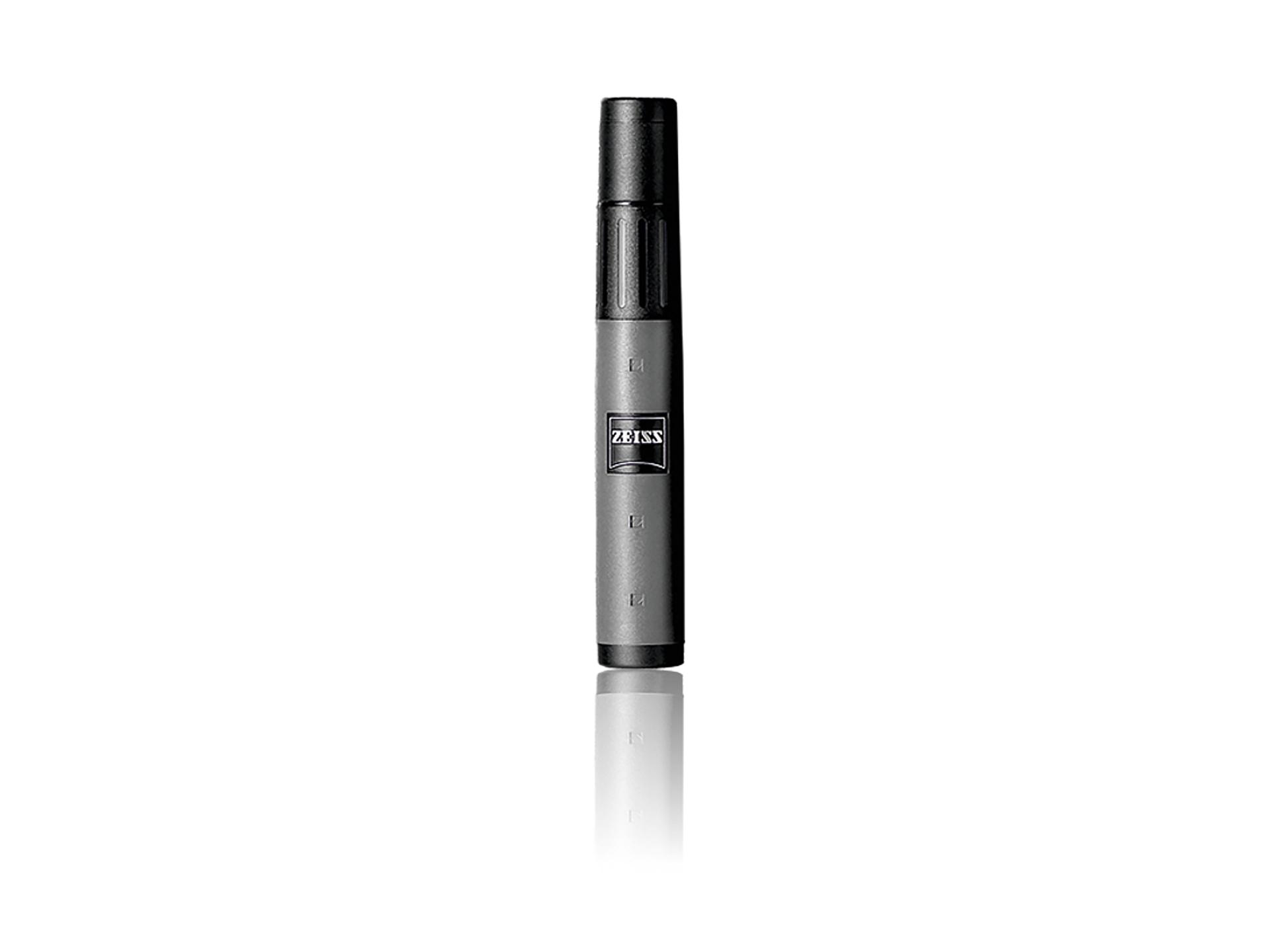 Black and gray ZEISS lens cleaning brush with logo, standing upright on a white reflective surface.