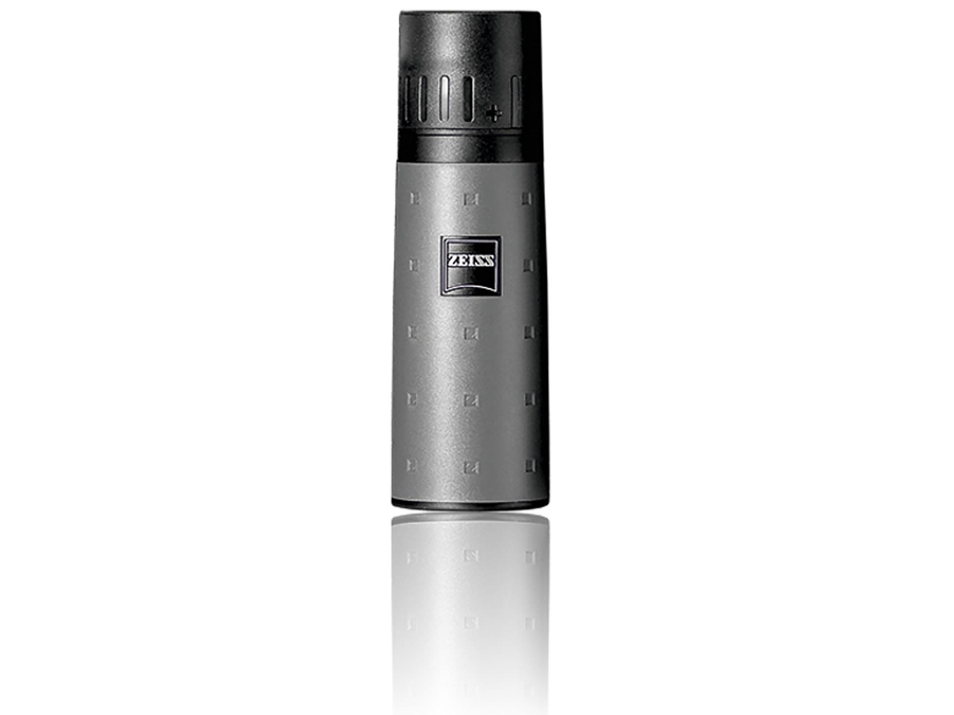 Compact, cylindrical ZEISS monocular with a textured grey body and black top, standing upright on a white reflective surface.