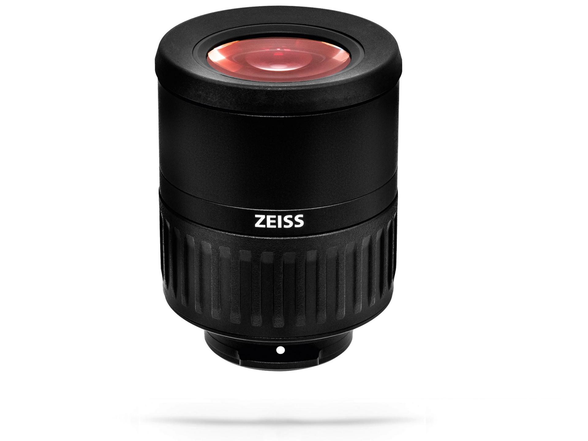 Black cylindrical ZEISS camera lens with a red-tinted front element, isolated on a white background.