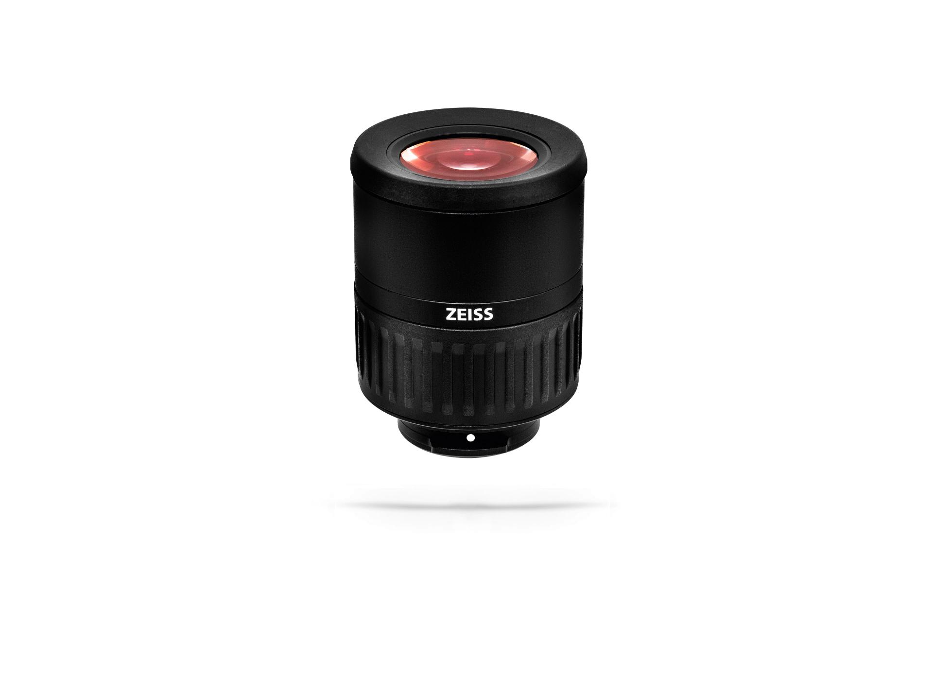 Black cylindrical ZEISS camera lens with a red-tinted front element, isolated on a white background.