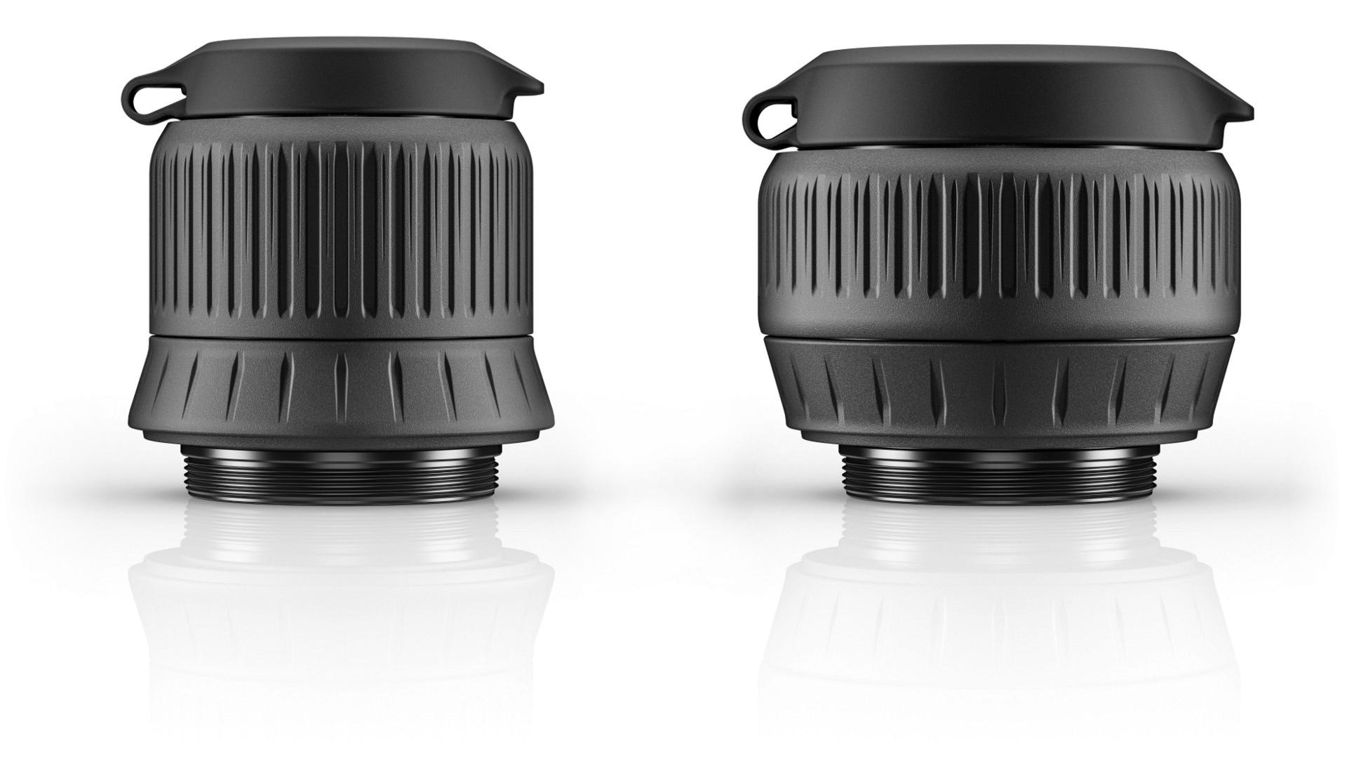 Two ZEISS camera lens housings with protective caps are displayed side by side on a white reflective surface.