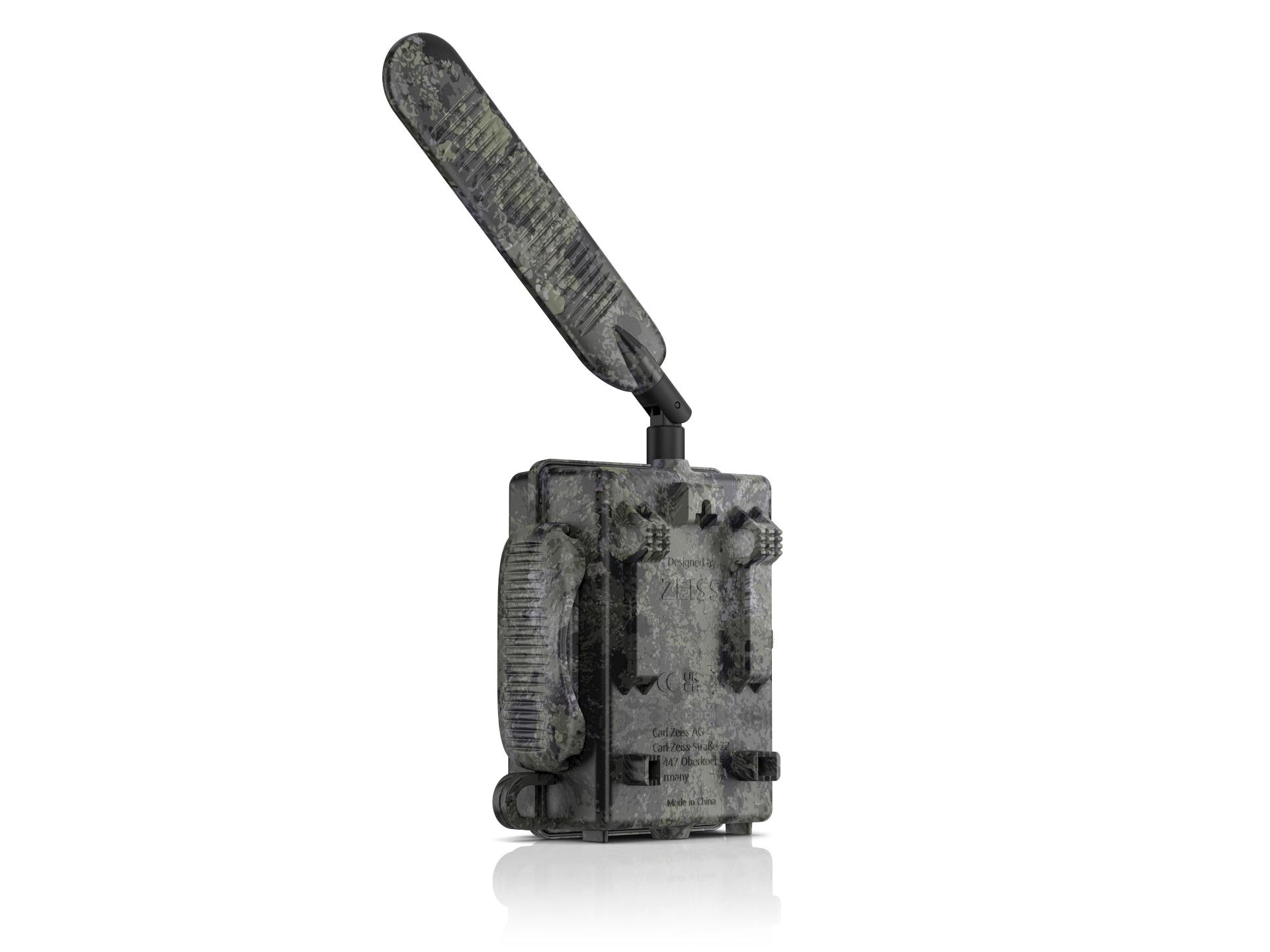 Camouflaged trail camera with an extended antenna, designed for outdoor use, shown against a white background.