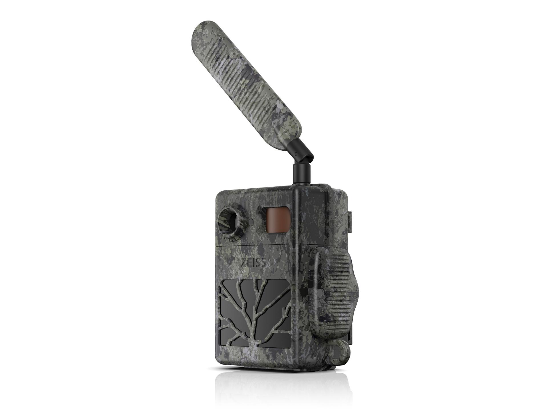 Camouflage-patterned ZEISS trail camera with an extended antenna and rugged design, standing upright on a white background.