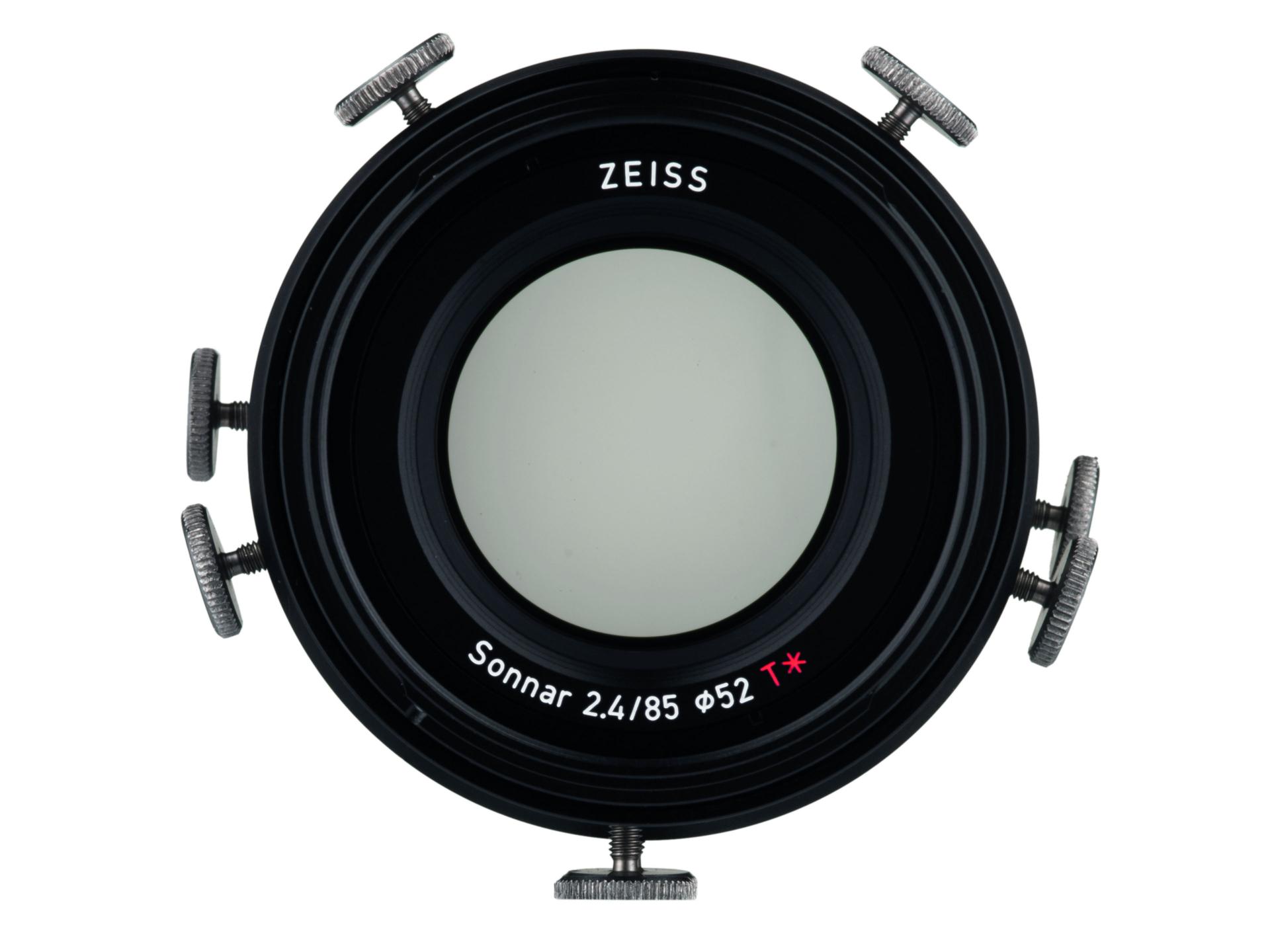 Front view of a ZEISS Sonnar 2.4/85 camera lens with adjustable mounting screws around the outer ring.