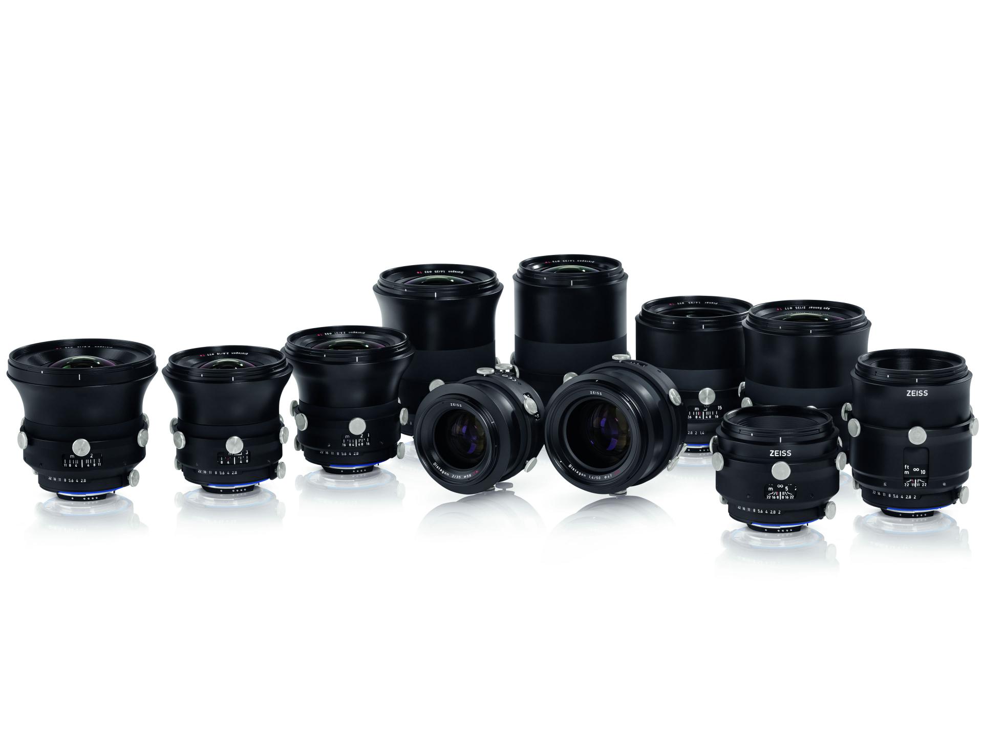 A collection of eleven professional ZEISS camera lenses arranged in rows on a white background.
