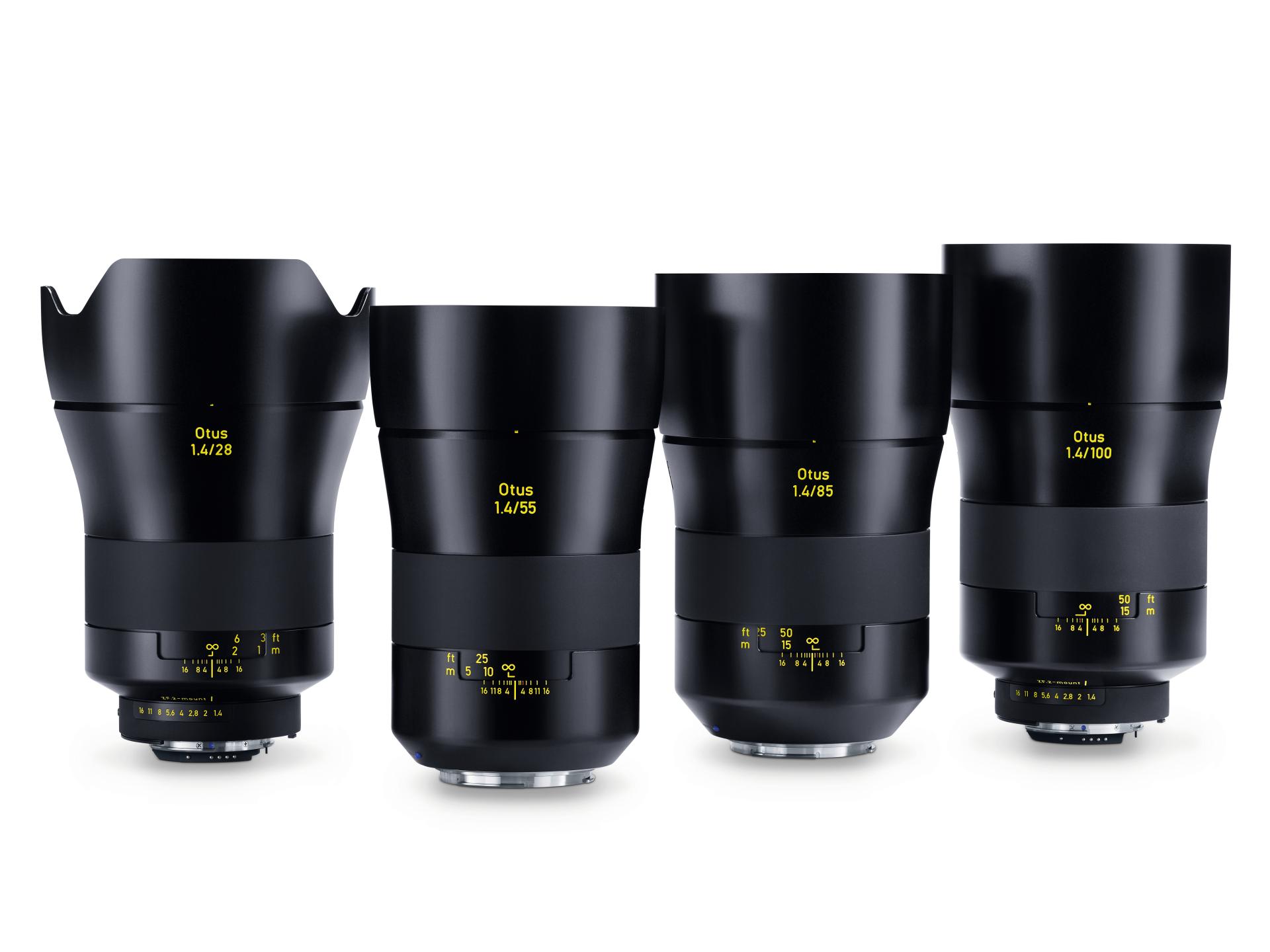 Four ZEISS Otus camera lenses of varying focal lengths are standing upright in a row against a white background.