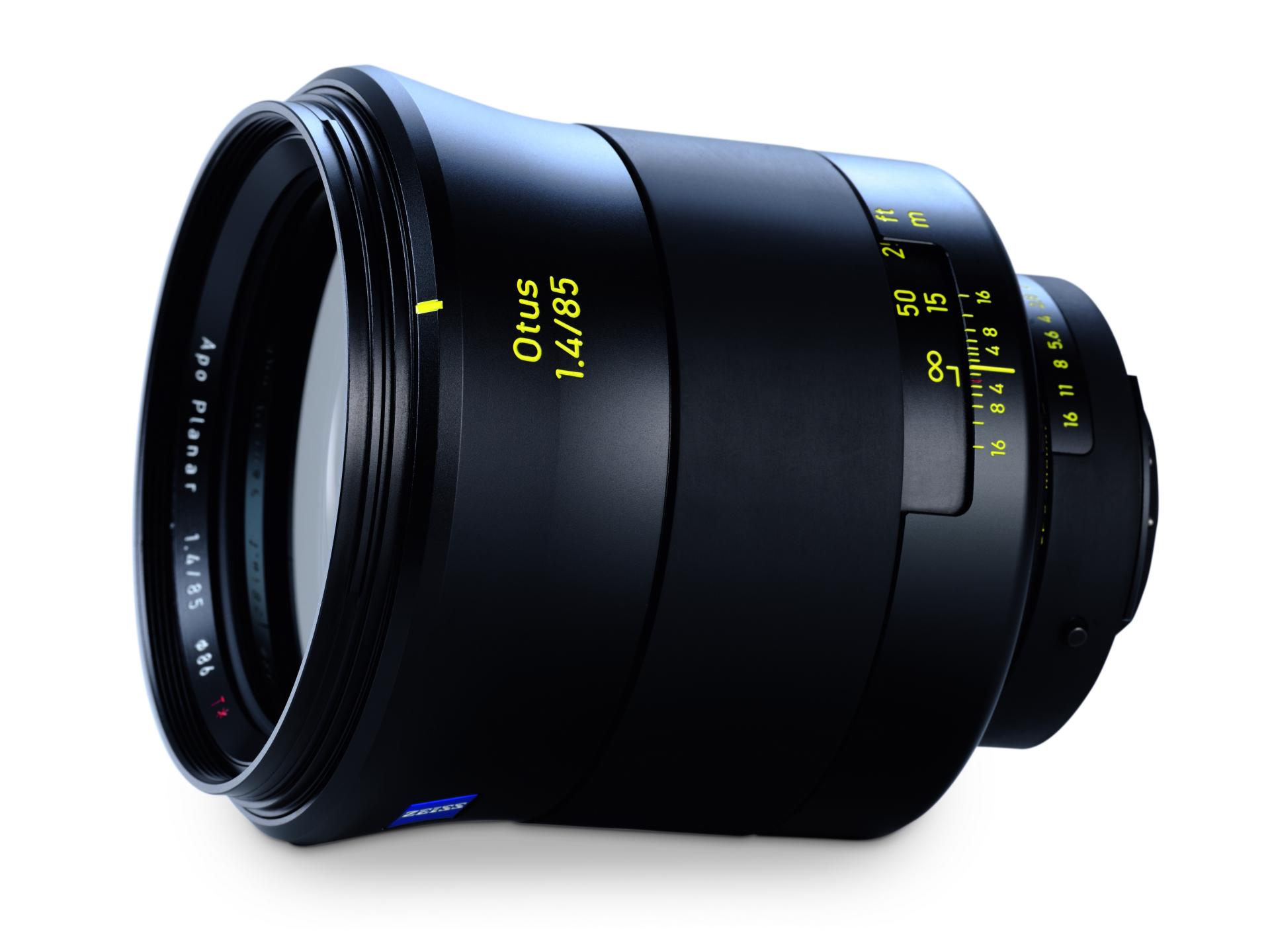 Close-up image of a ZEISS Otus 1.4/85 camera lens with visible focus and aperture markings.