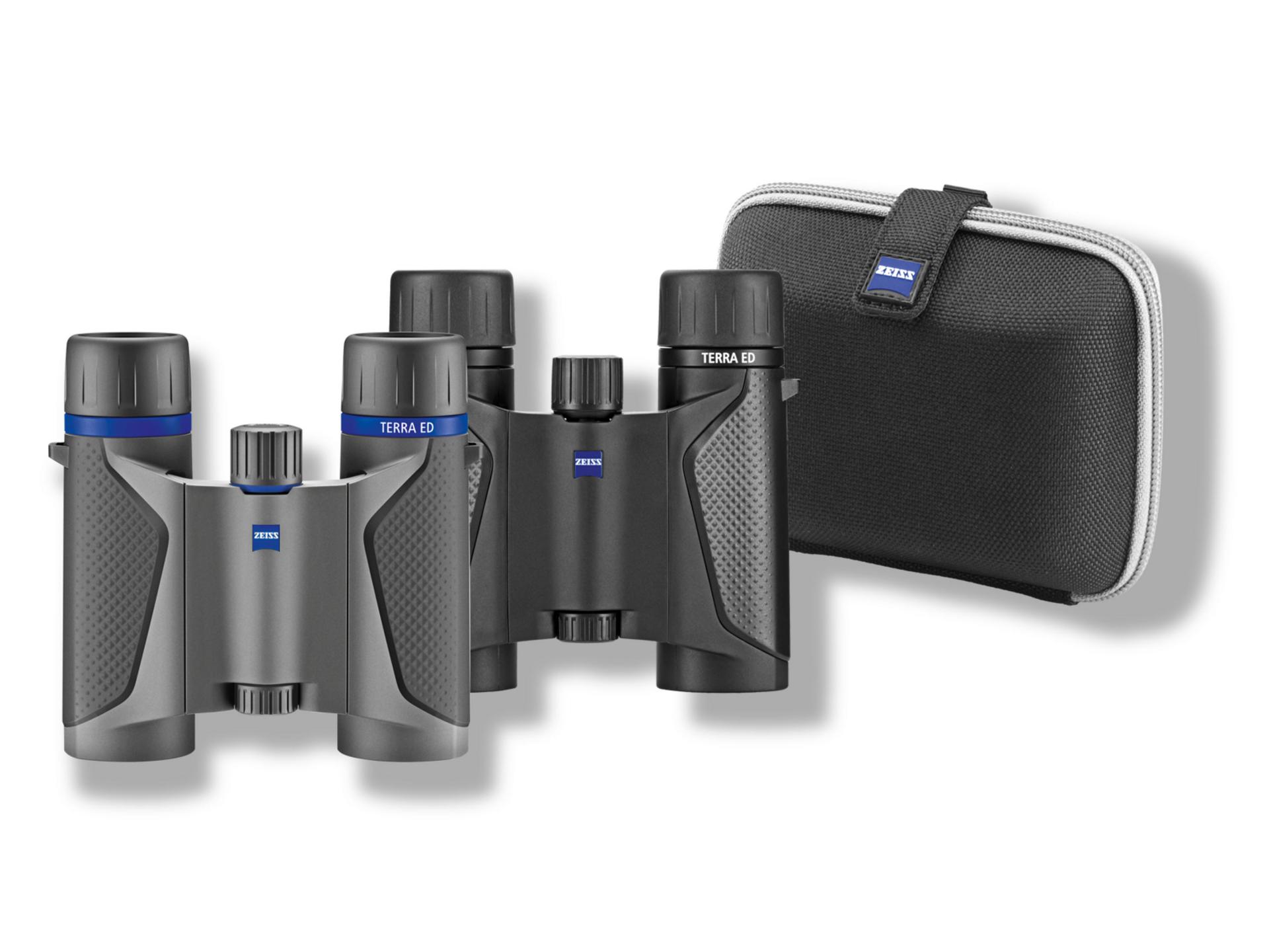 Two compact ZEISS binoculars with textured grips are displayed in front of a black and gray ZEISS-branded carrying case.