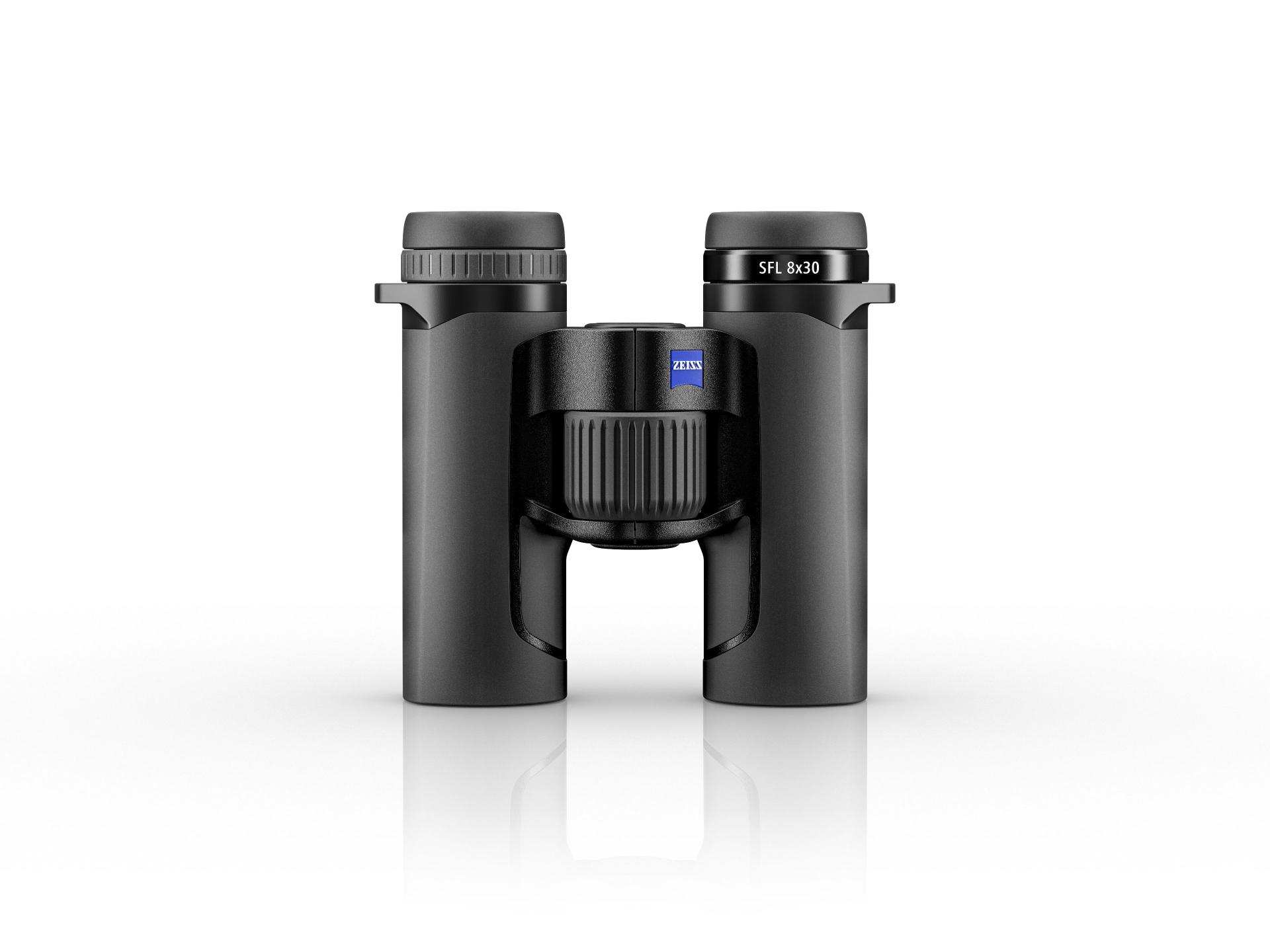 Black ZEISS SFL 8x30 binoculars shown standing upright on a white reflective surface, viewed from the front.