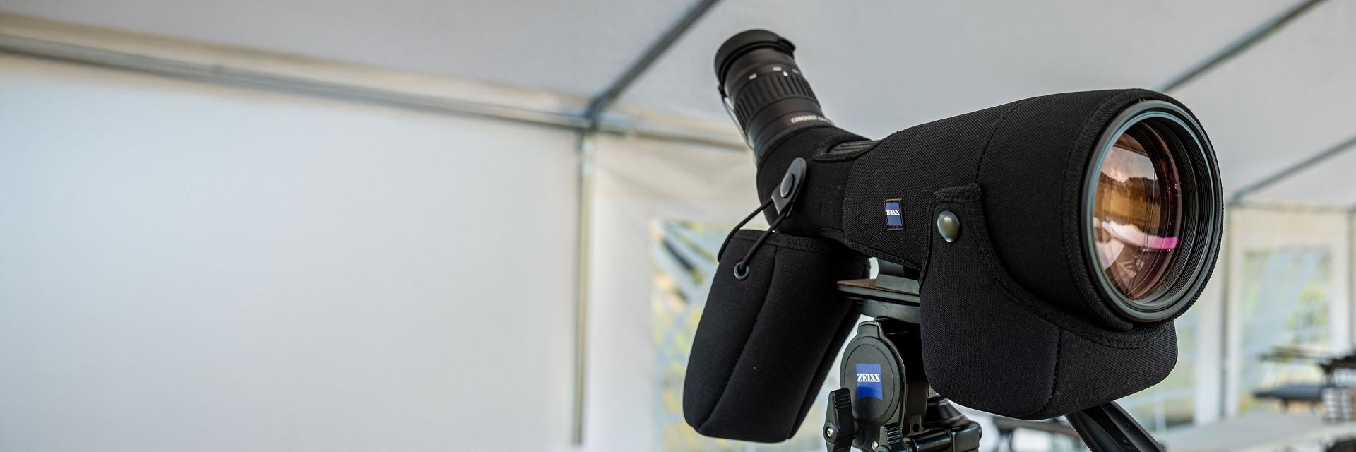 High-quality ZEISS spotting scope mounted on a tripod under a canopy.