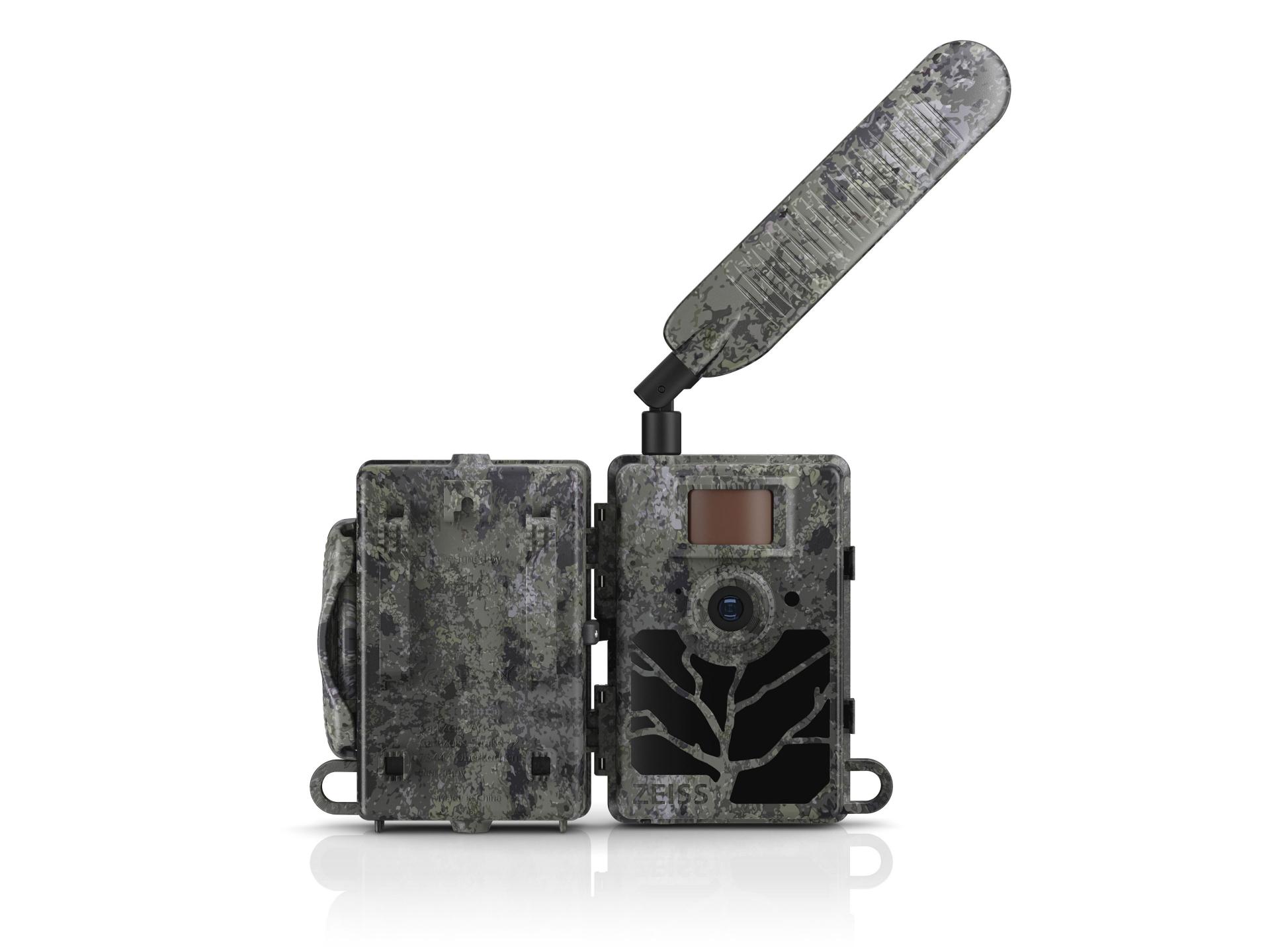Camouflaged ZEISS trail camera with an open protective cover and an extended antenna, designed for outdoor wildlife monitoring.