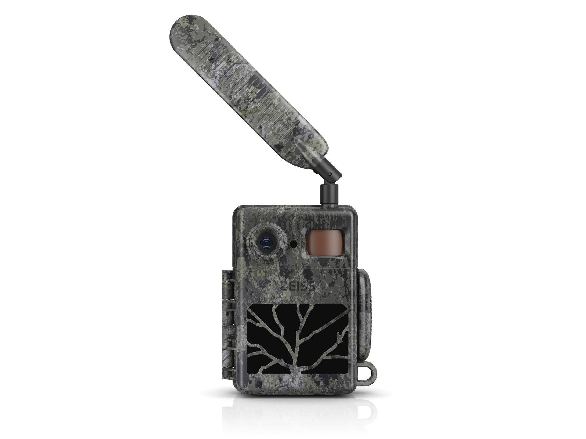 Camouflaged ZEISS trail camera with an extended antenna and a black panel featuring a tree-branch design on the front.