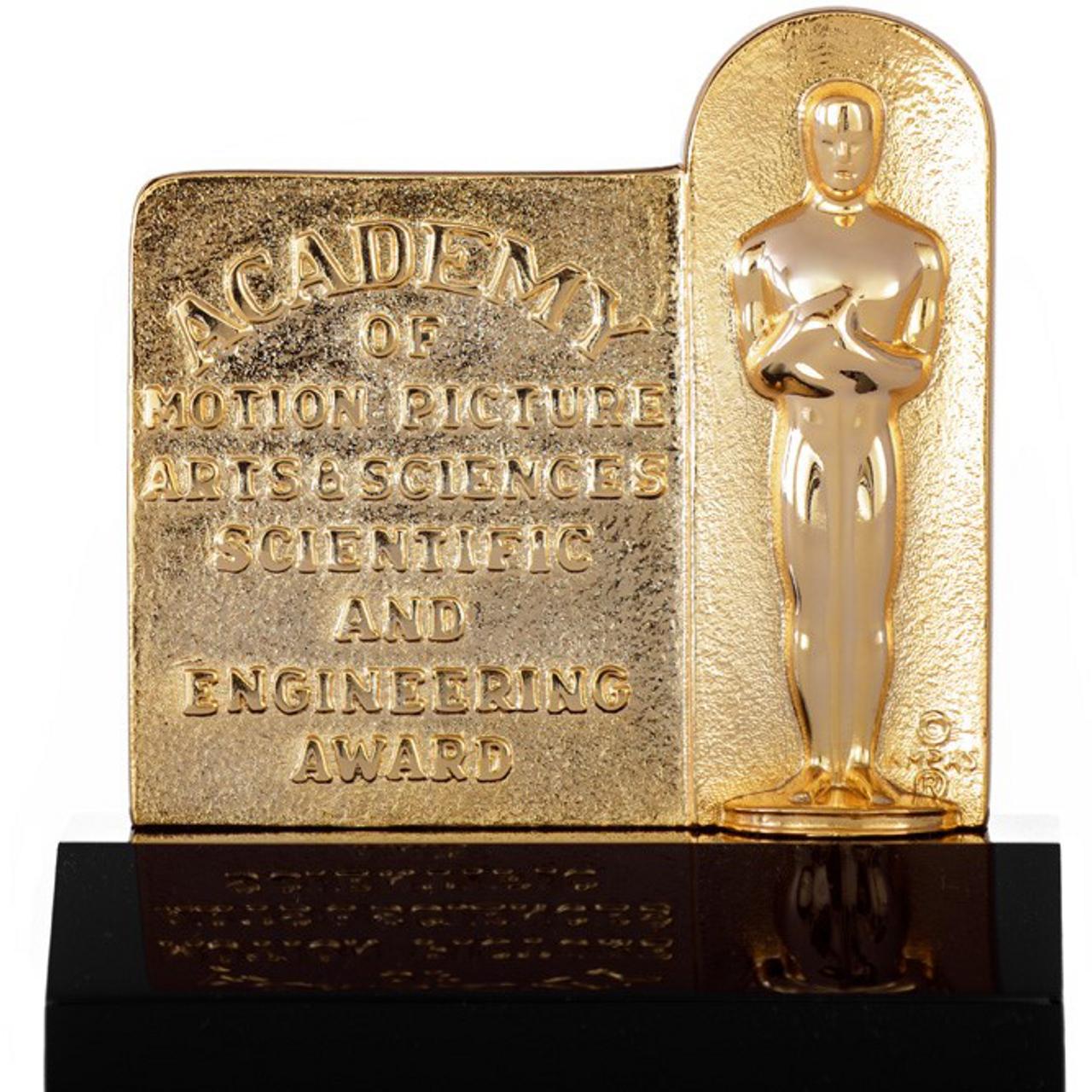 Golden Scientific and Engineering Award plaque from the Academy of Motion Picture Arts and Sciences, displayed on a black base.