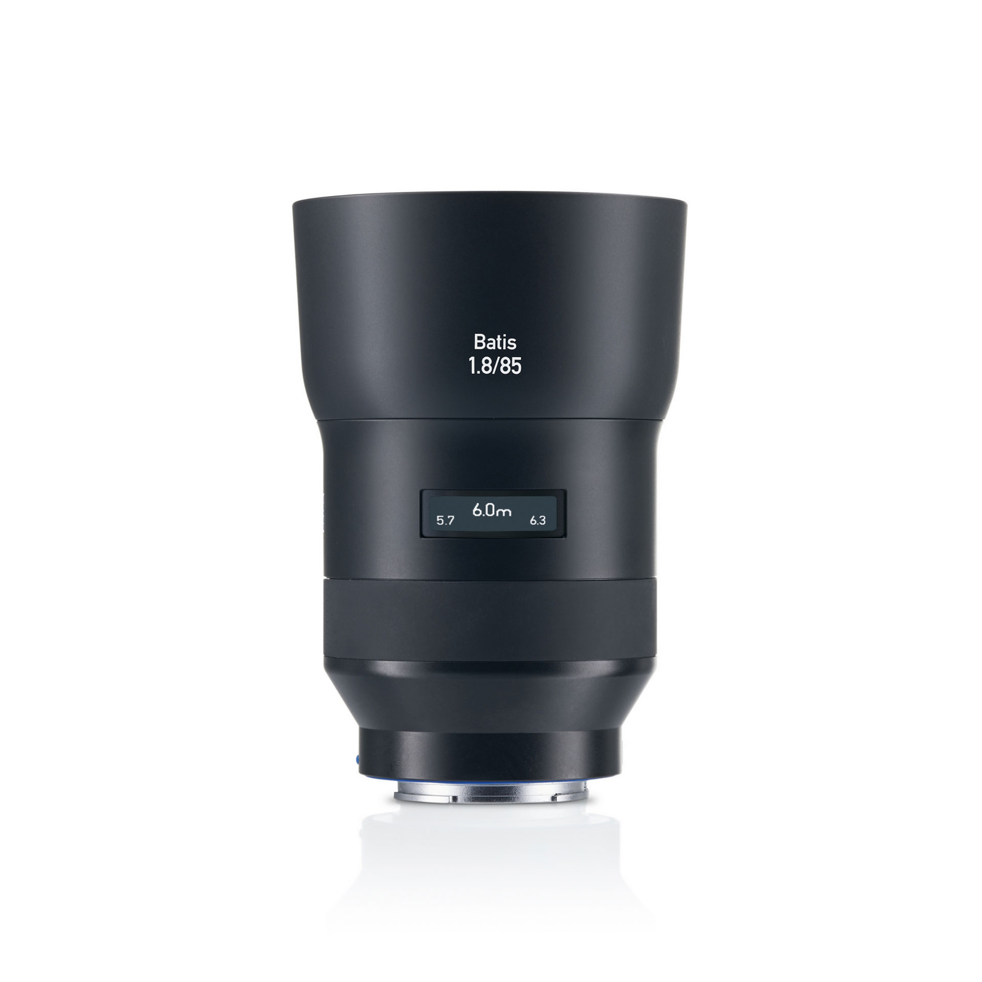 Black ZEISS Batis 85mm f/1.8 camera lens standing upright with an OLED display showing focus distance.