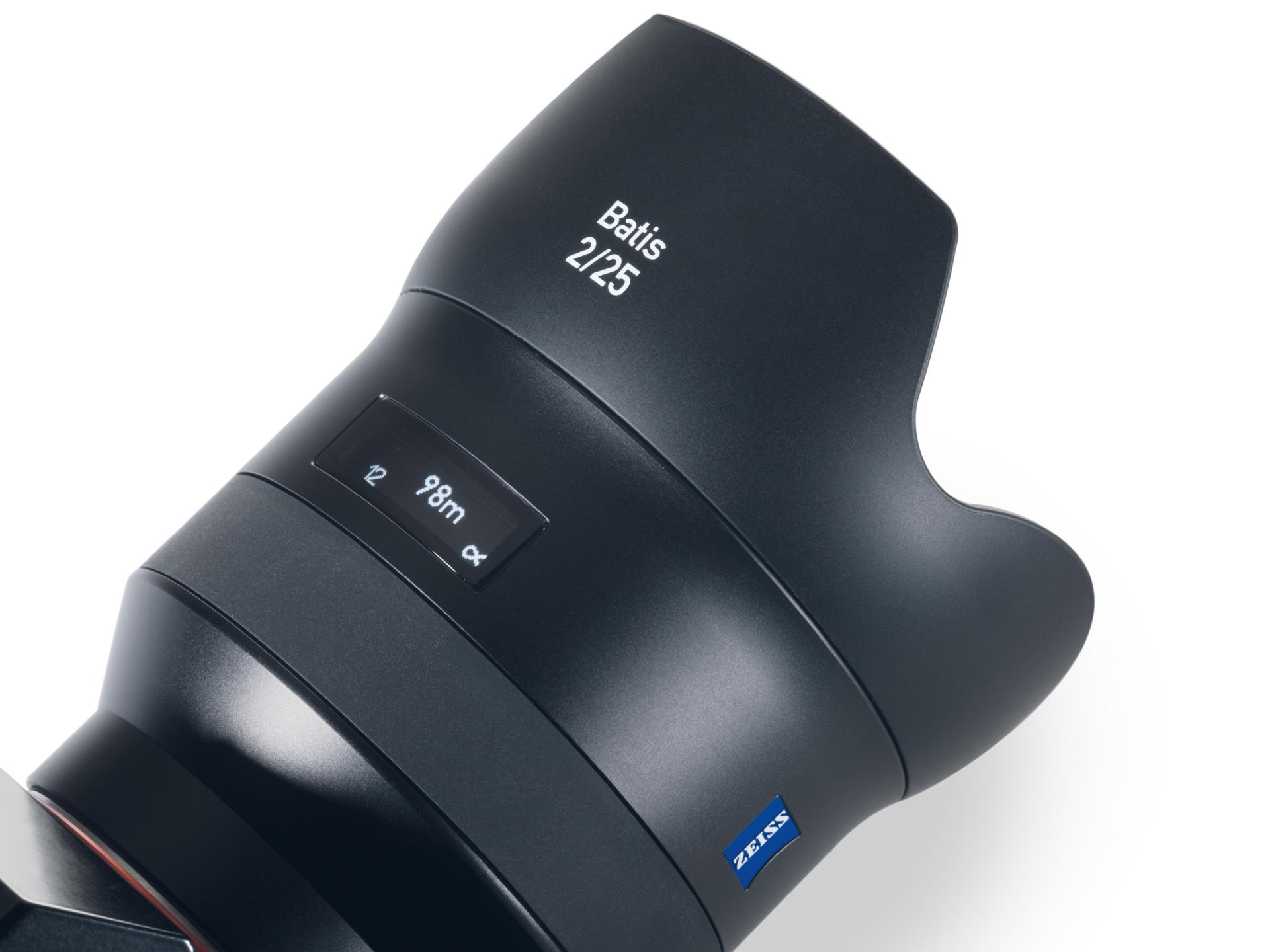 Close-up view of a ZEISS Batis 2/25 camera lens featuring a digital display and sleek black finish.