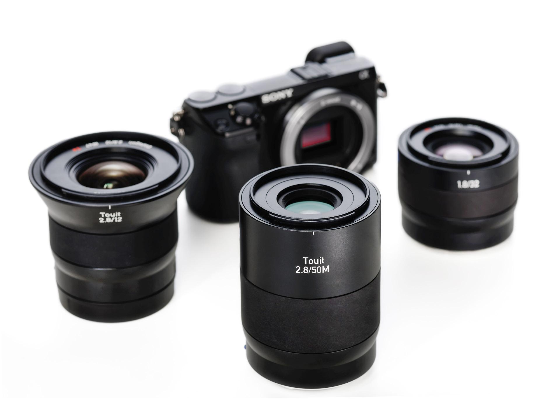 Rear view of a ZEISS camera lens showing the metal mount, electronic contacts, and inner glass element.