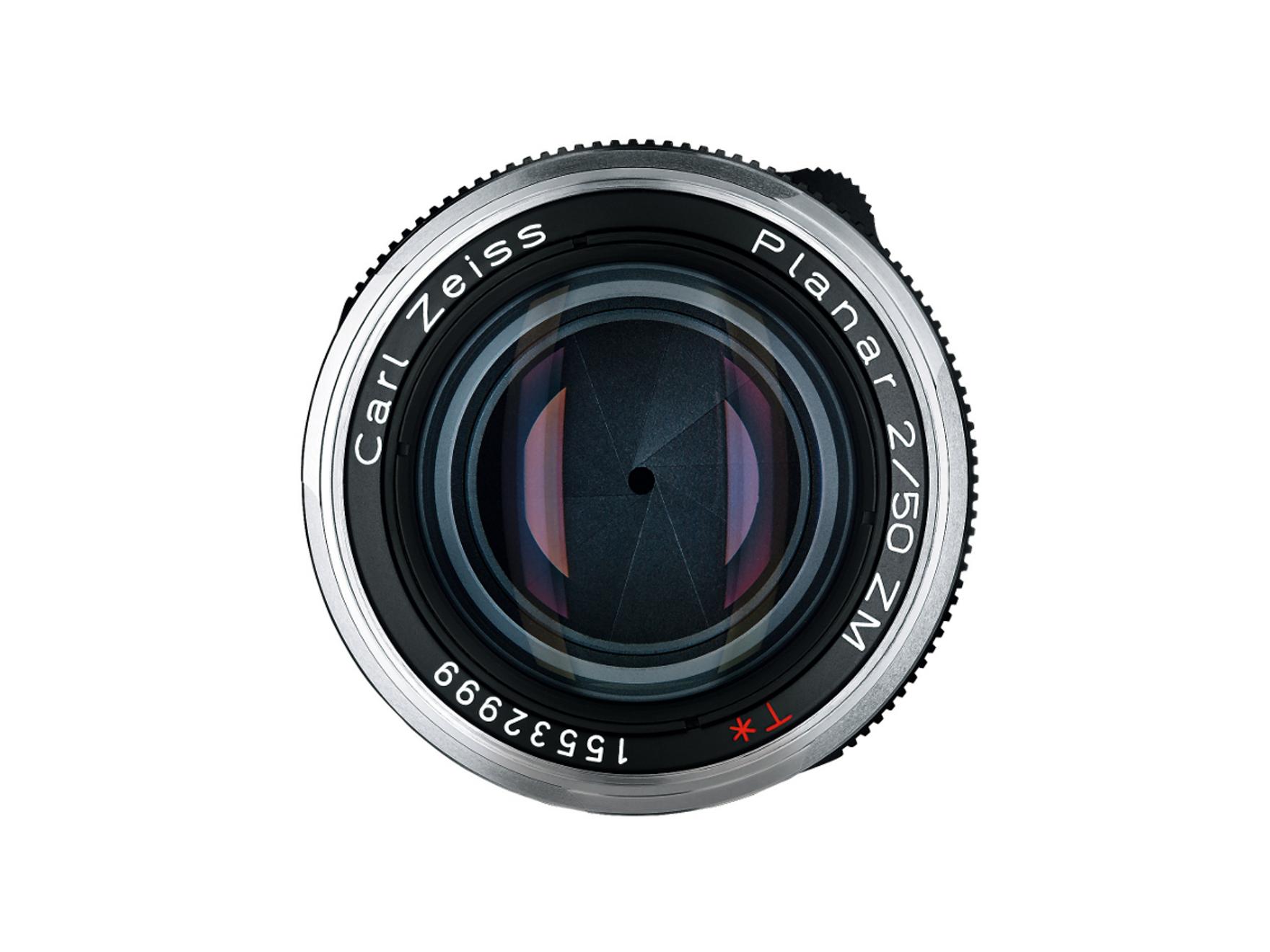 Front view of a ZEISS Planar 2/50 ZM camera lens showing the aperture blades and engraved model details.