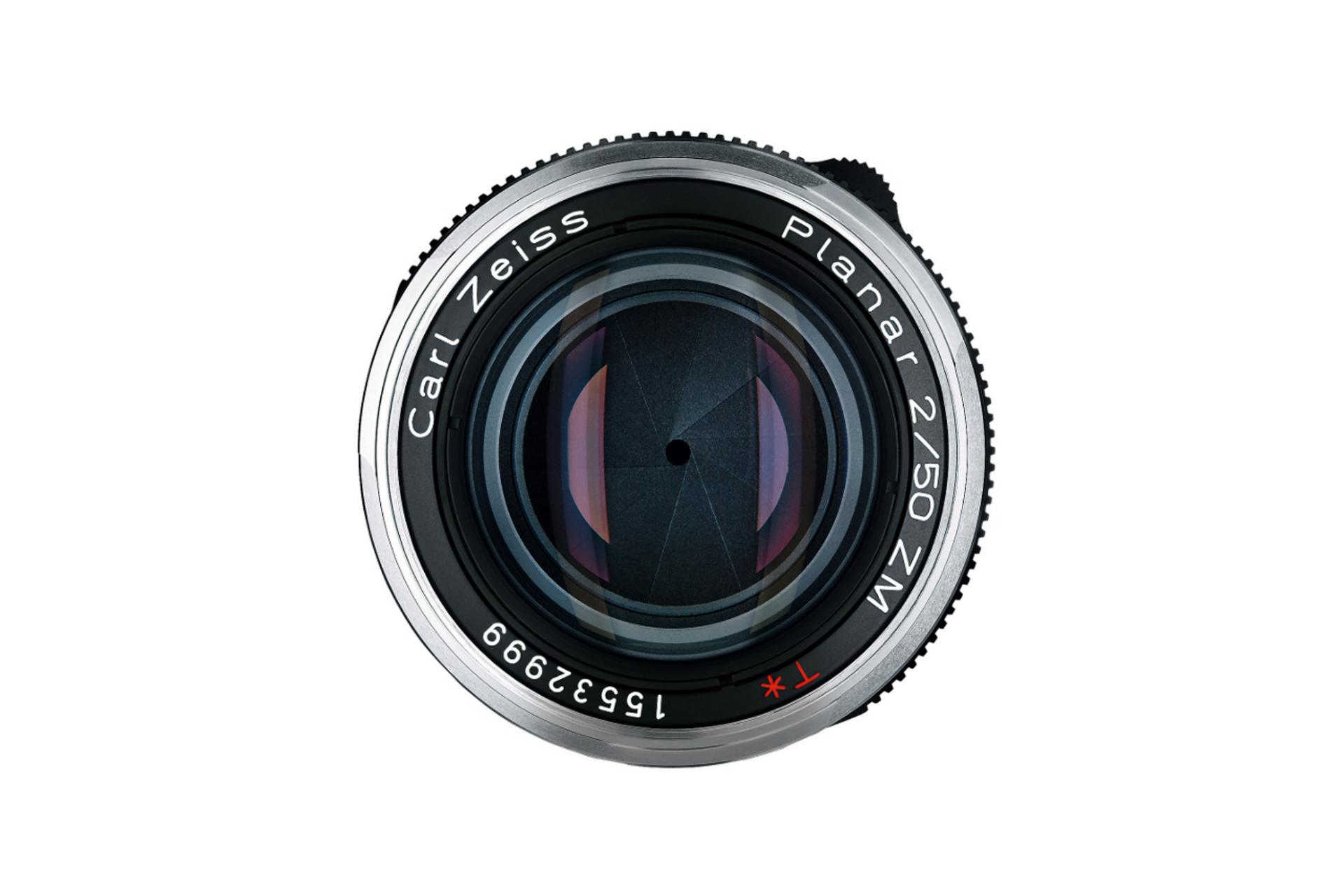 Front view of a ZEISS Planar 2/50 ZM camera lens showing the aperture blades and engraved model details.