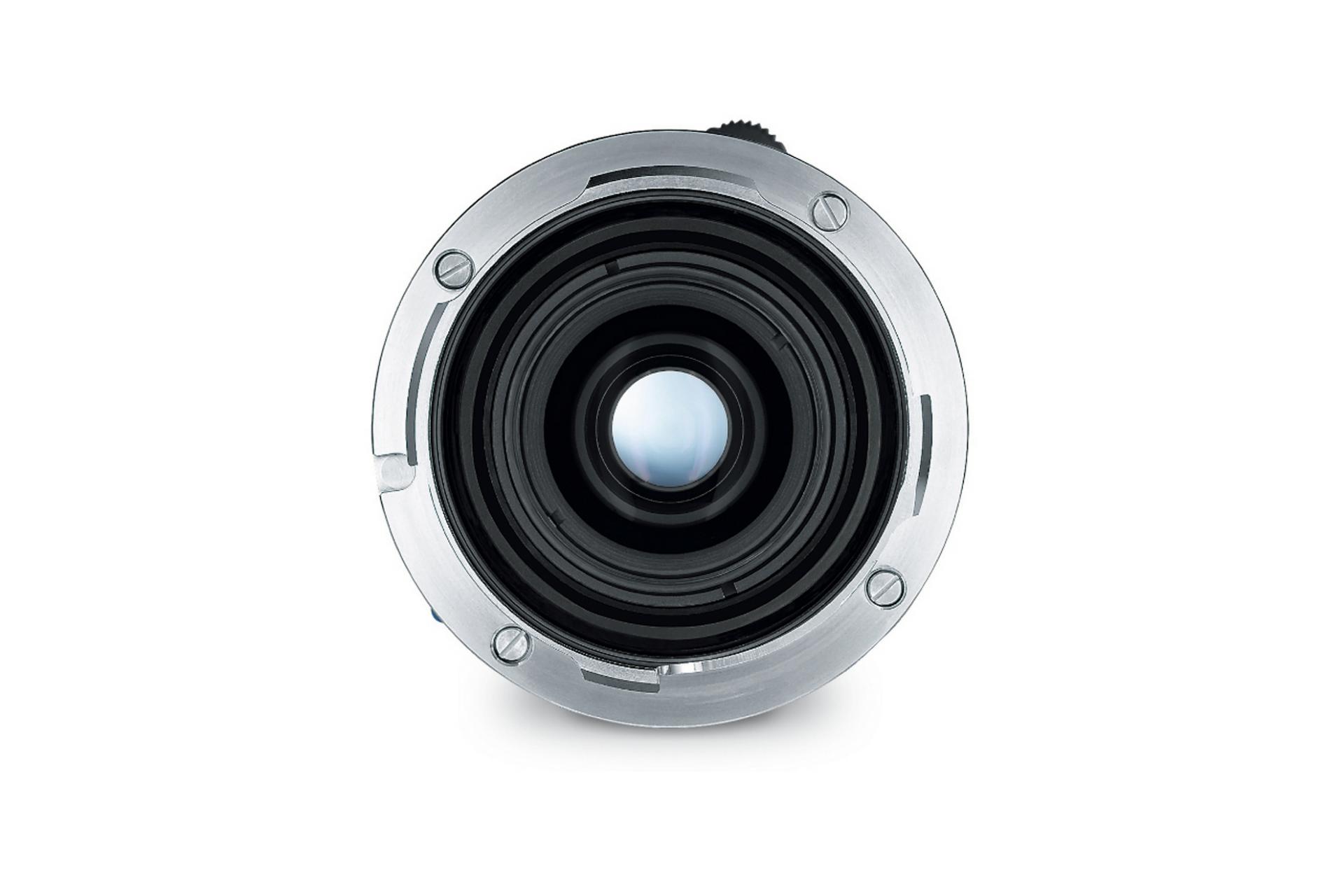 Close-up view of the rear element of a ZEISS camera lens showing its metal mount and glass optics.