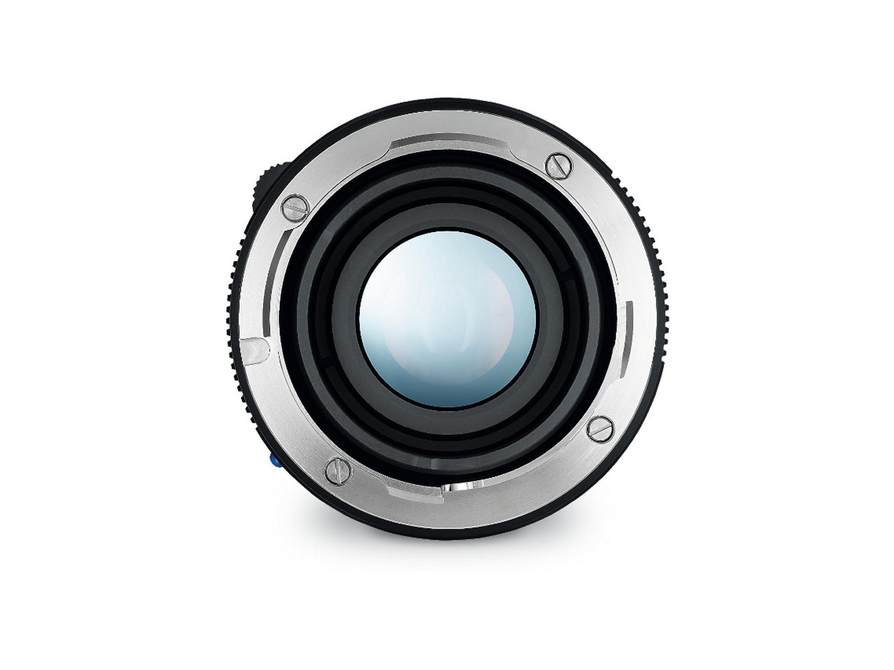 Close-up view of a ZEISS camera lens with a metallic mount and central glass element.