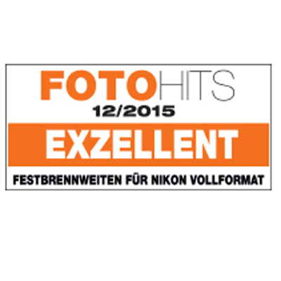 Award label from FOTOHITS magazine, issue 12/2015, rating ZEISS prime lenses for Nikon full-frame as "EXZELLENT" (excellent) in bold orange and black text.