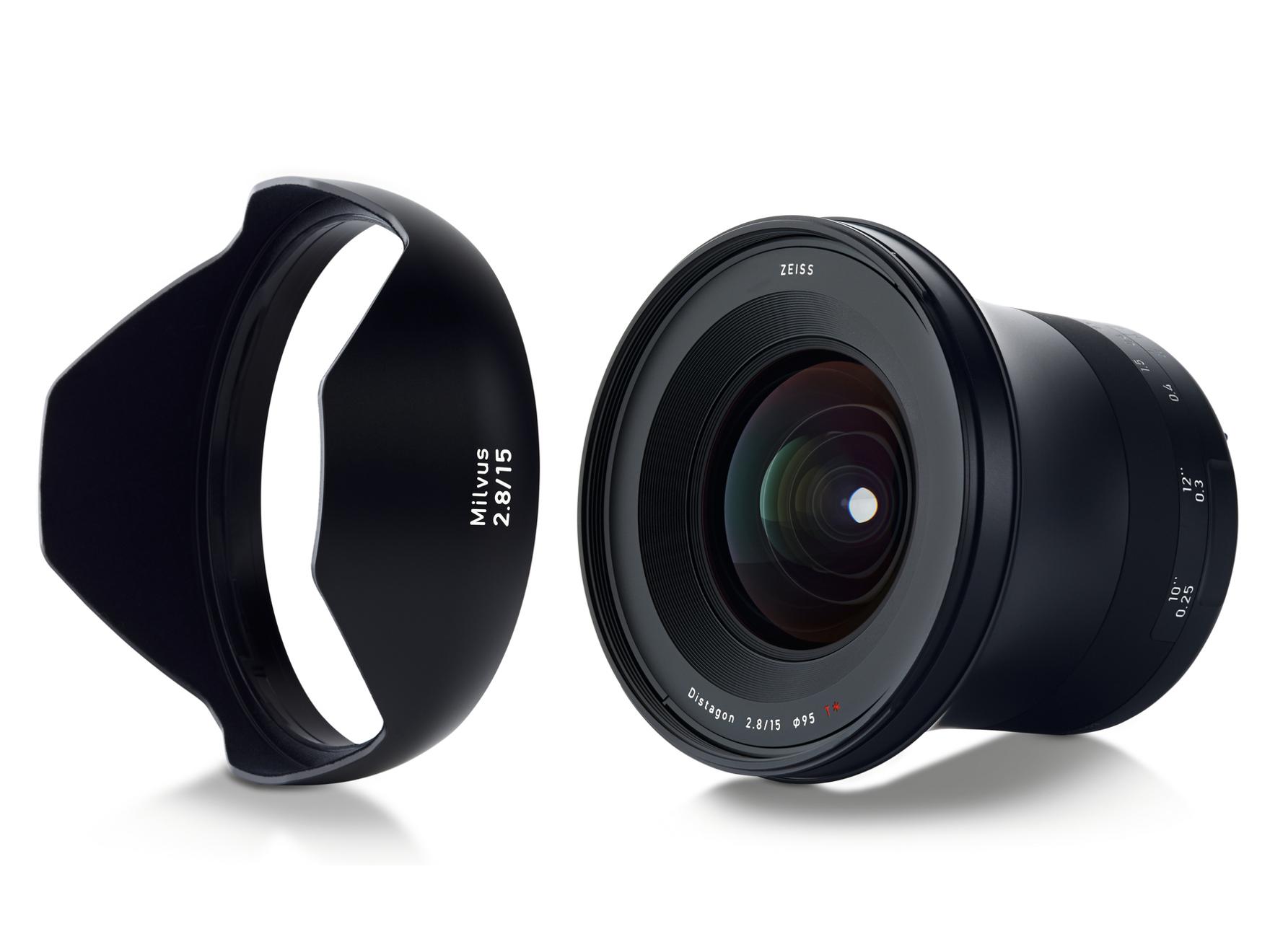 Wide-angle ZEISS Milvus 2.8/15 camera lens displayed with its matching lens hood on a white background.