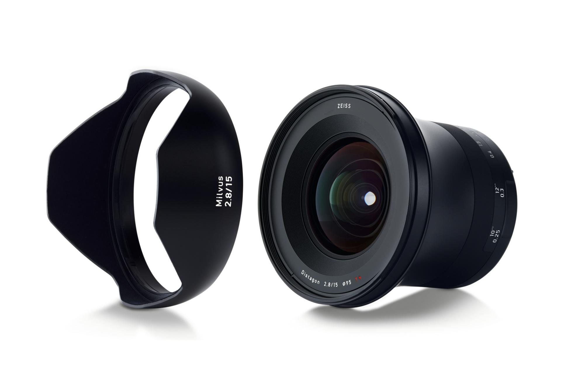 Wide-angle ZEISS Milvus 2.8/15 camera lens displayed with its matching lens hood on a white background.