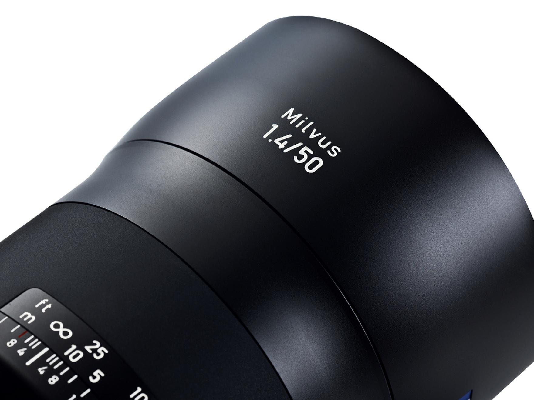 Close-up view of a ZEISS Milvus 1.4/50 camera lens showcasing its sleek black design and engraved aperture and focus markings.