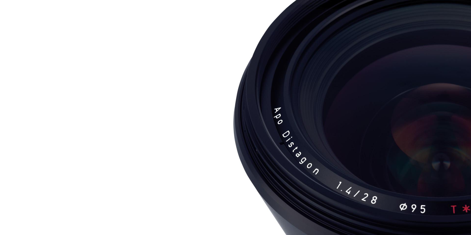 Close-up view of a ZEISS Apo Distagon 1.4/55 camera lens showing detailed glass and engraved text.