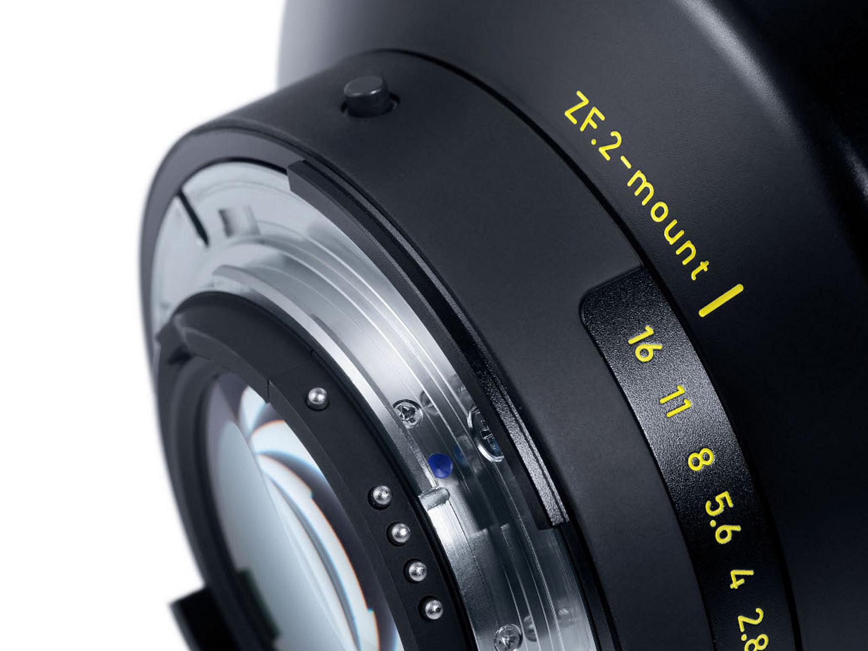 Close-up view of a ZEISS camera lens mount labeled "ZE-2-mount" with aperture values clearly marked in yellow.