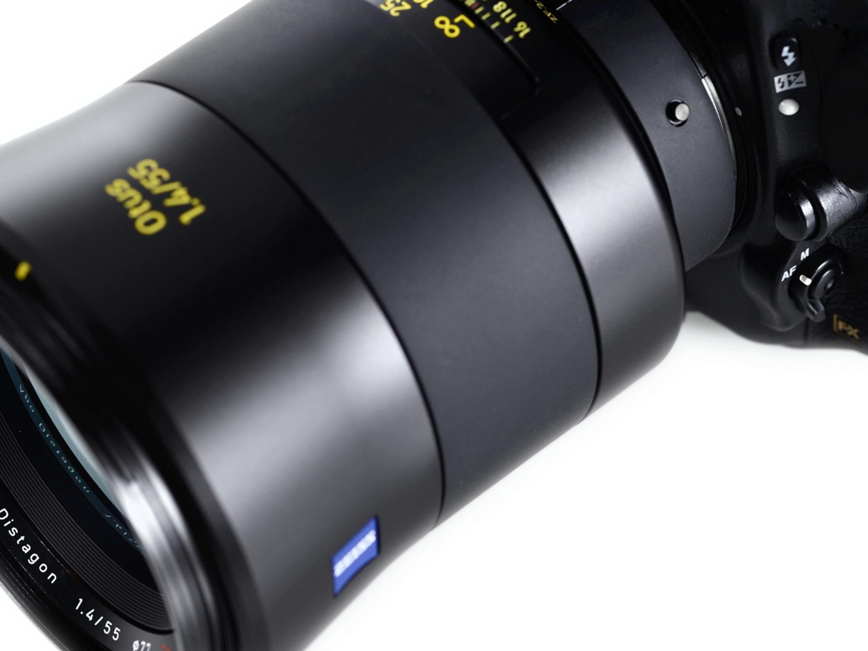 Close-up view of a ZEISS Otus 1.4/55 camera lens mounted on a professional DSLR camera body.