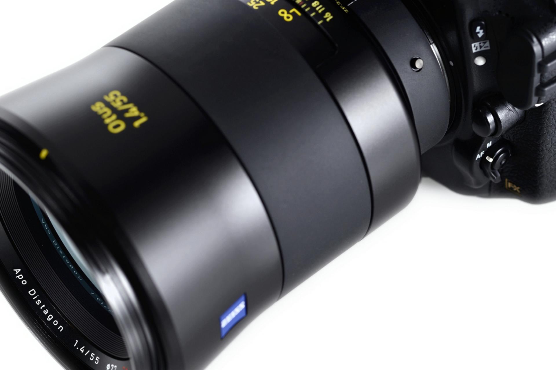 Close-up view of a ZEISS Otus 1.4/55 camera lens mounted on a professional DSLR camera body.