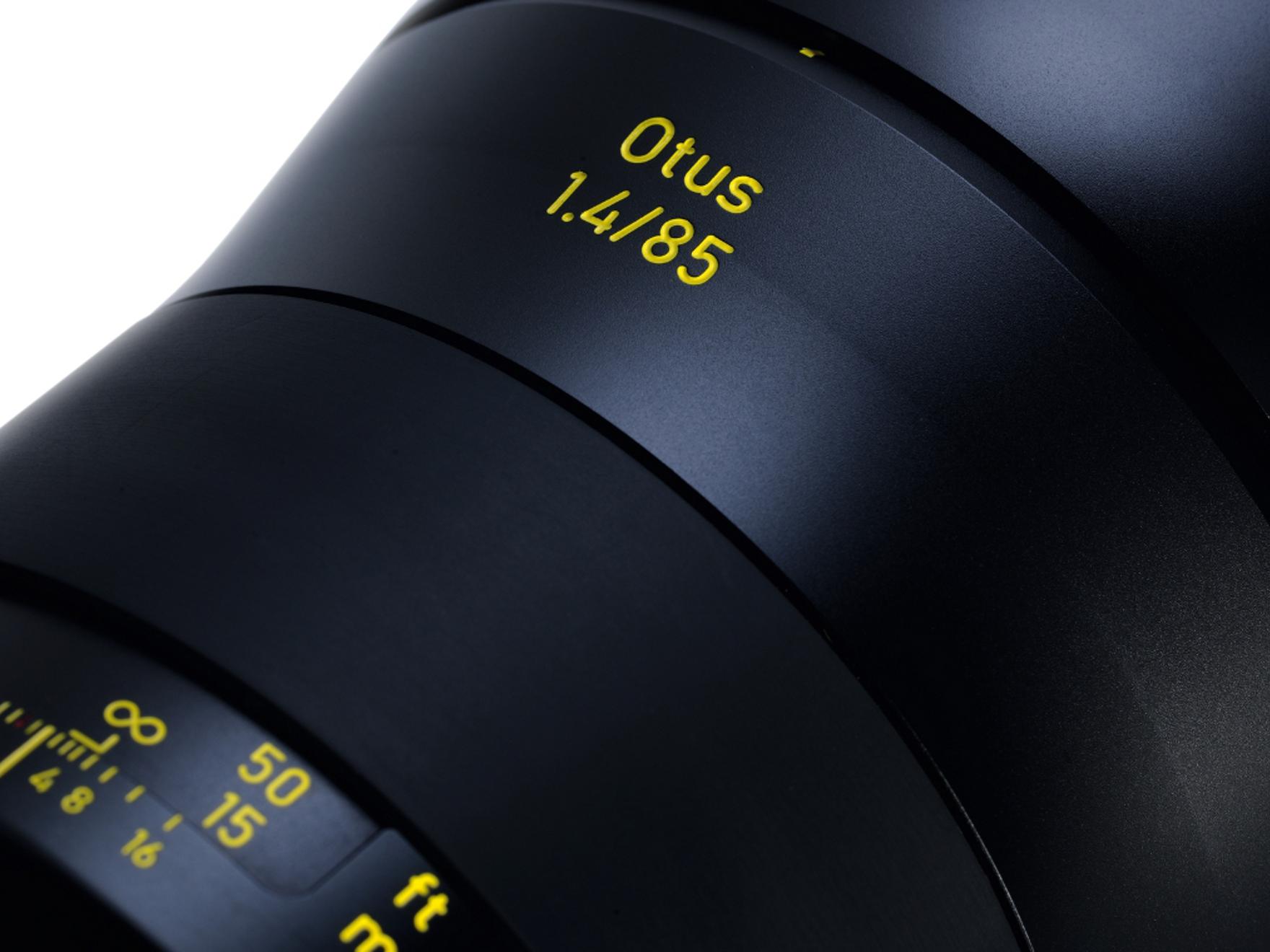 Close-up view of a ZEISS Otus 1.4/85 camera lens showing detailed focus and aperture markings.