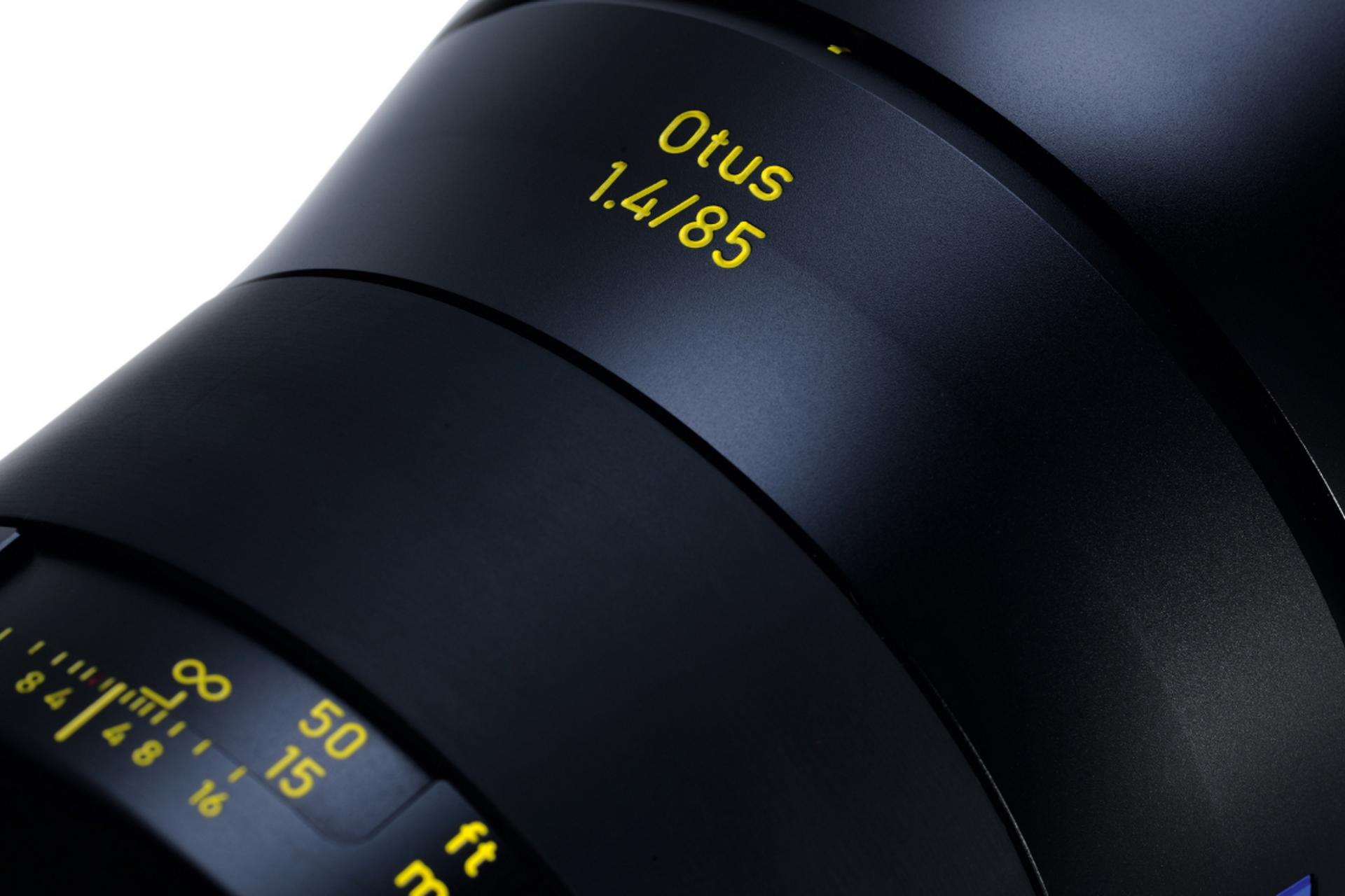Close-up view of a ZEISS Otus 1.4/85 camera lens showing detailed focus and aperture markings.